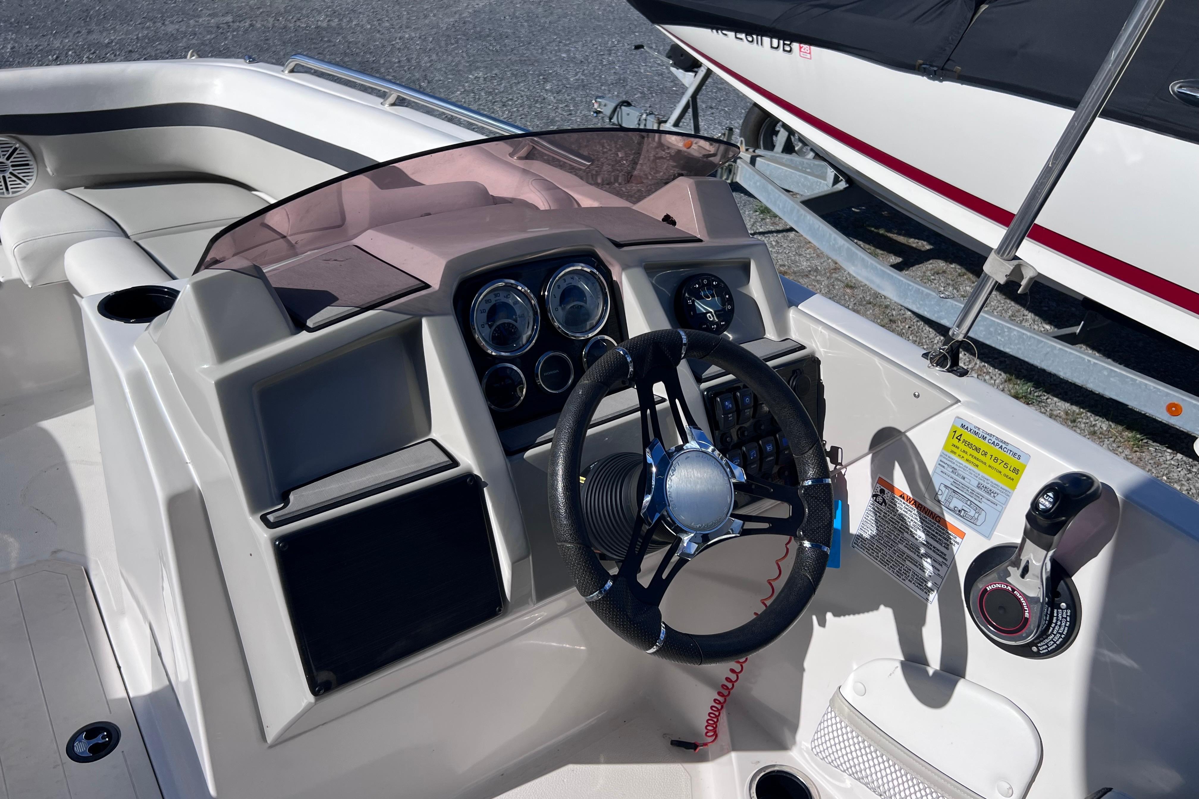 2021 Starcraft SVX 211 OB boat dashboard with steering wheel and control panel.