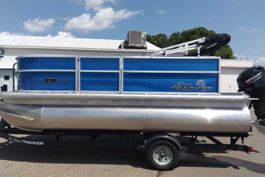 2026 Sun Tracker Party Barge 16 DLX pontoon boat with Mercury outboard motor.
