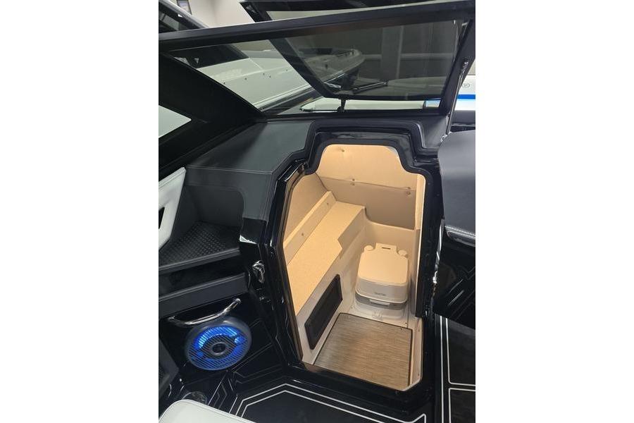 2026 Cobalt R8 Surf boat interior with storage compartment and modern speaker system.