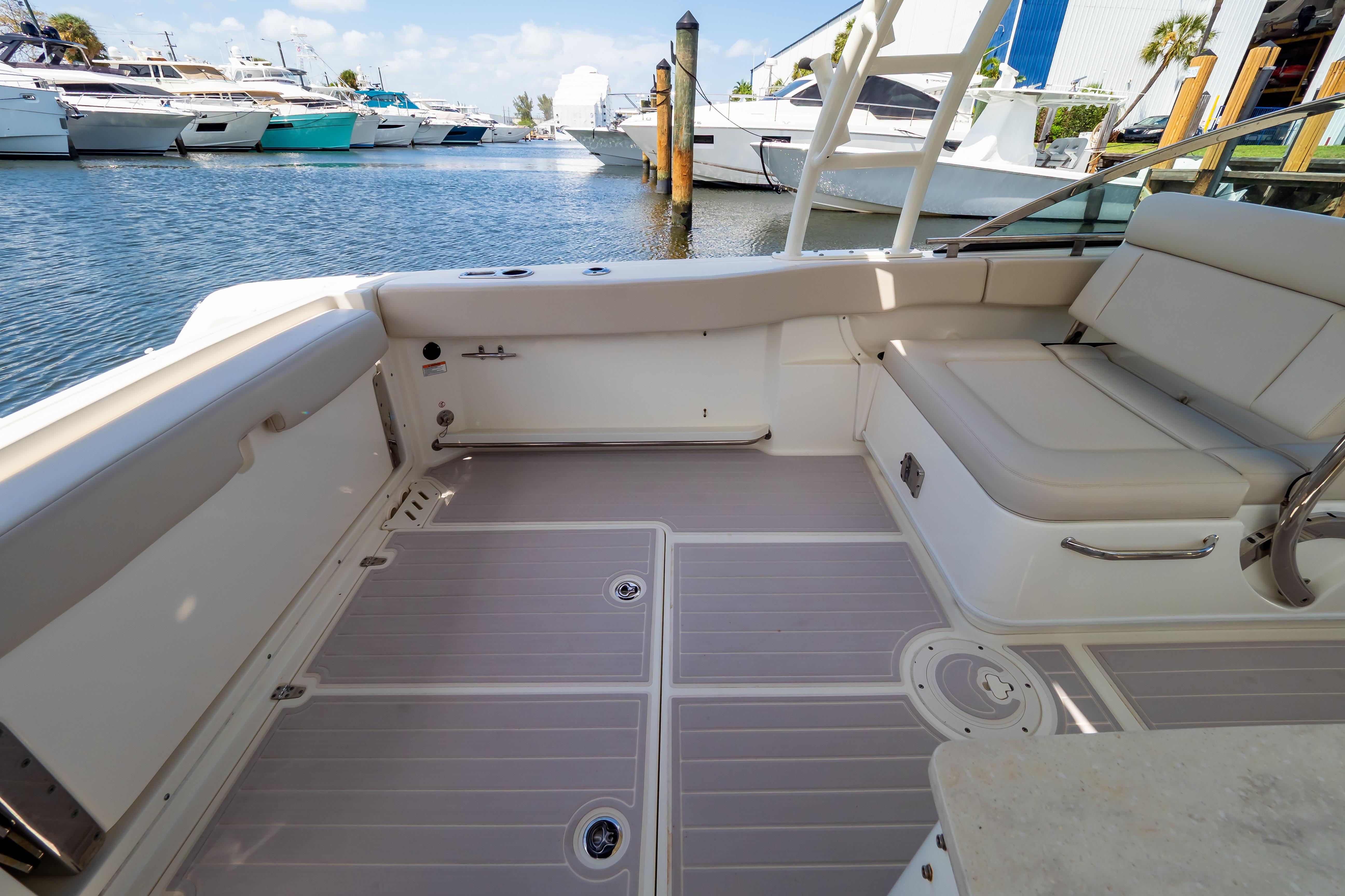 2019 Boston Whaler 270 Vantage boat interior with seating, docked at marina.