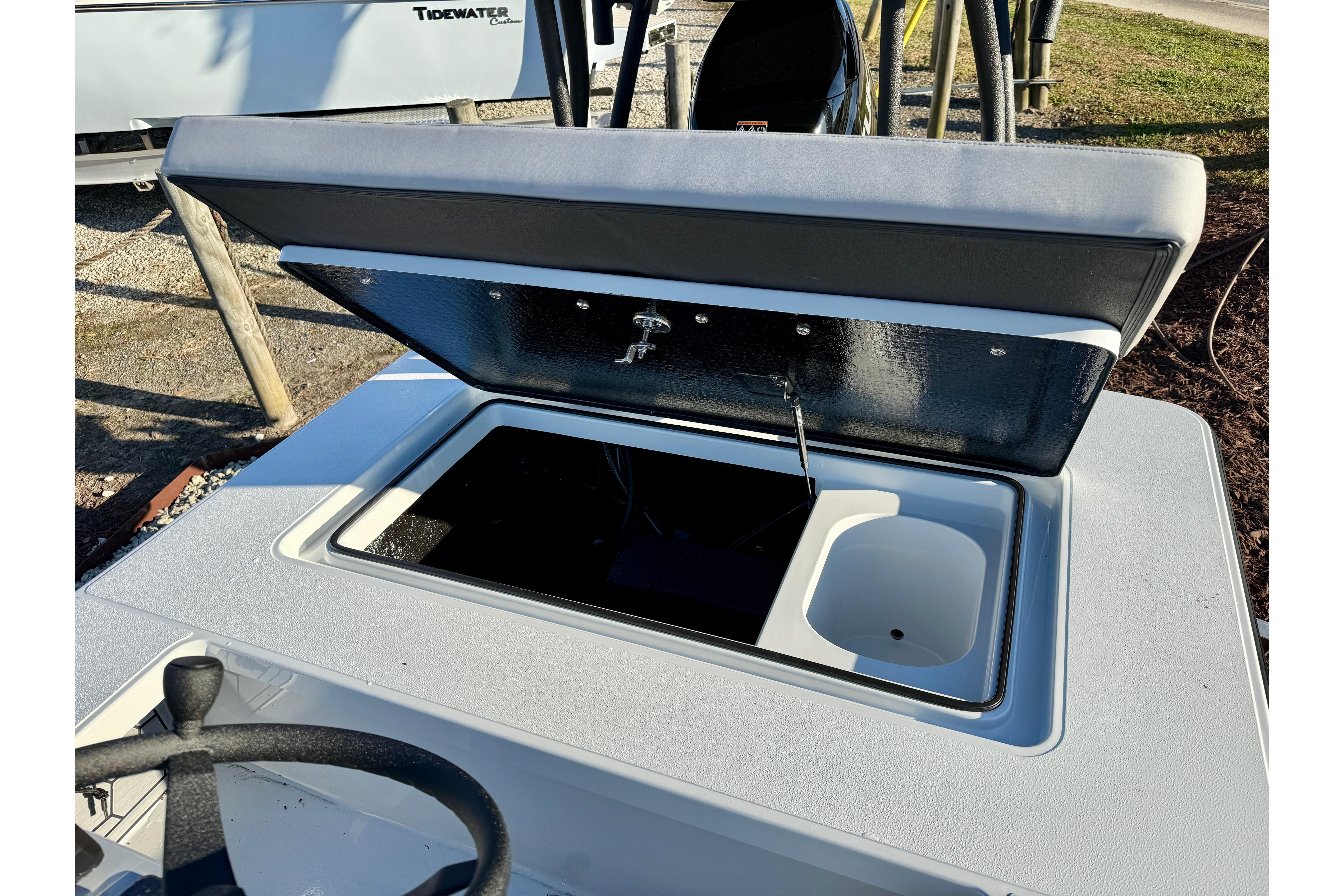 Open storage compartment on 2026 East Cape EVO 17V boat, showcasing interior design.