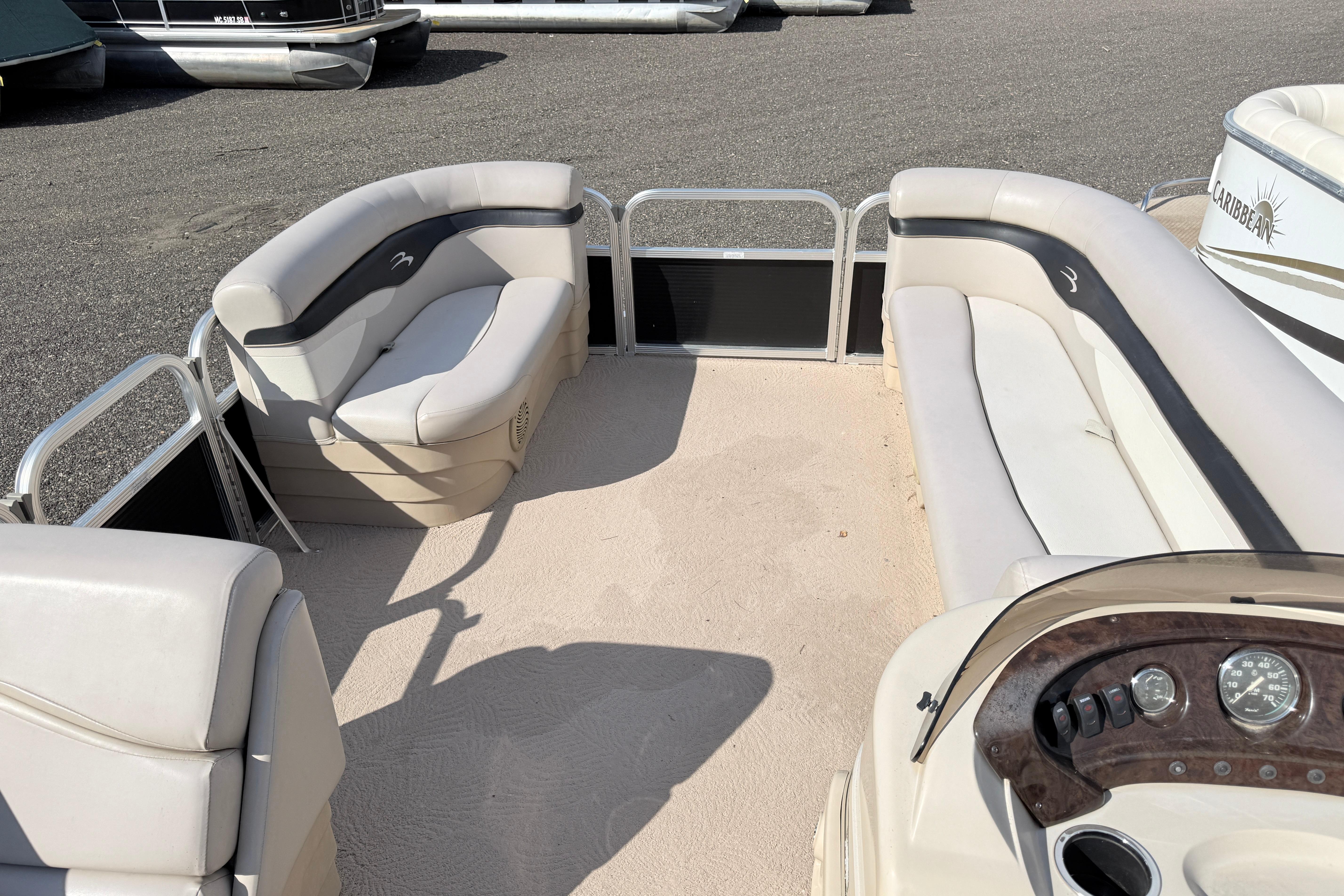 Interior of a 2010 Bennington 20SLi pontoon boat with beige seating and dashboard.
