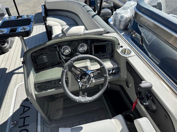 2025 Tahoe Pontoon 2585 LTZ Entertainer boat interior with steering console and seating.