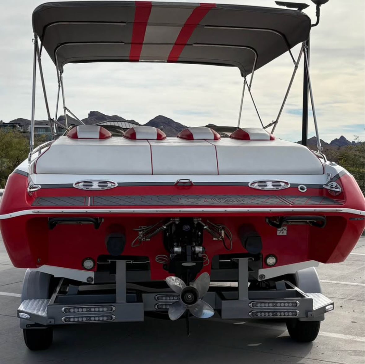 Red 2022 Conquest 28’ Top Cat II Deck Boat on trailer.