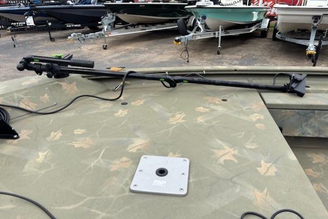 2017 Tracker Grizzly 1654 MVX Sportsman boat deck with camouflage pattern and mounted equipment.