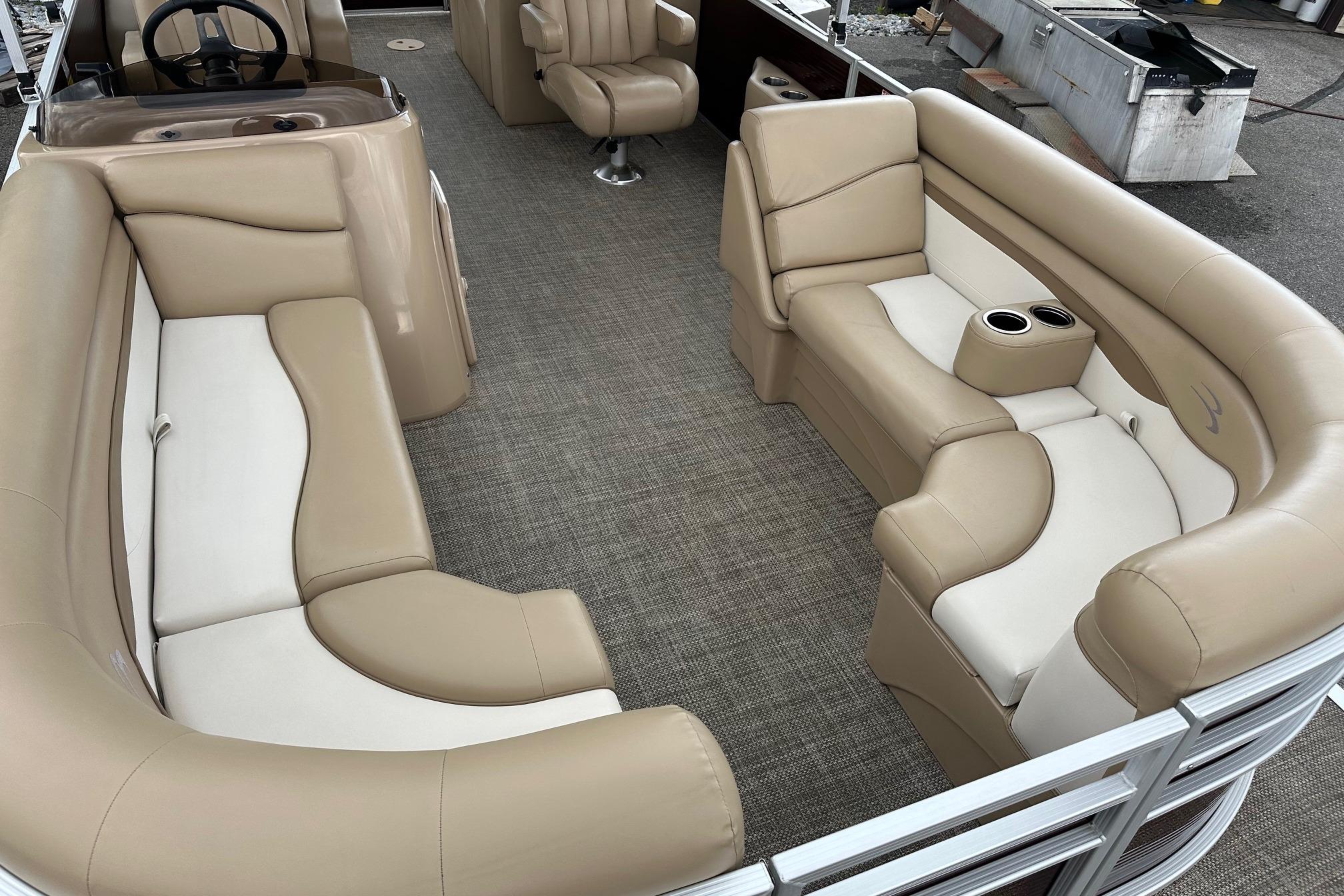 2016 Bennington 24 SCWX pontoon boat interior with beige seating and steering console.