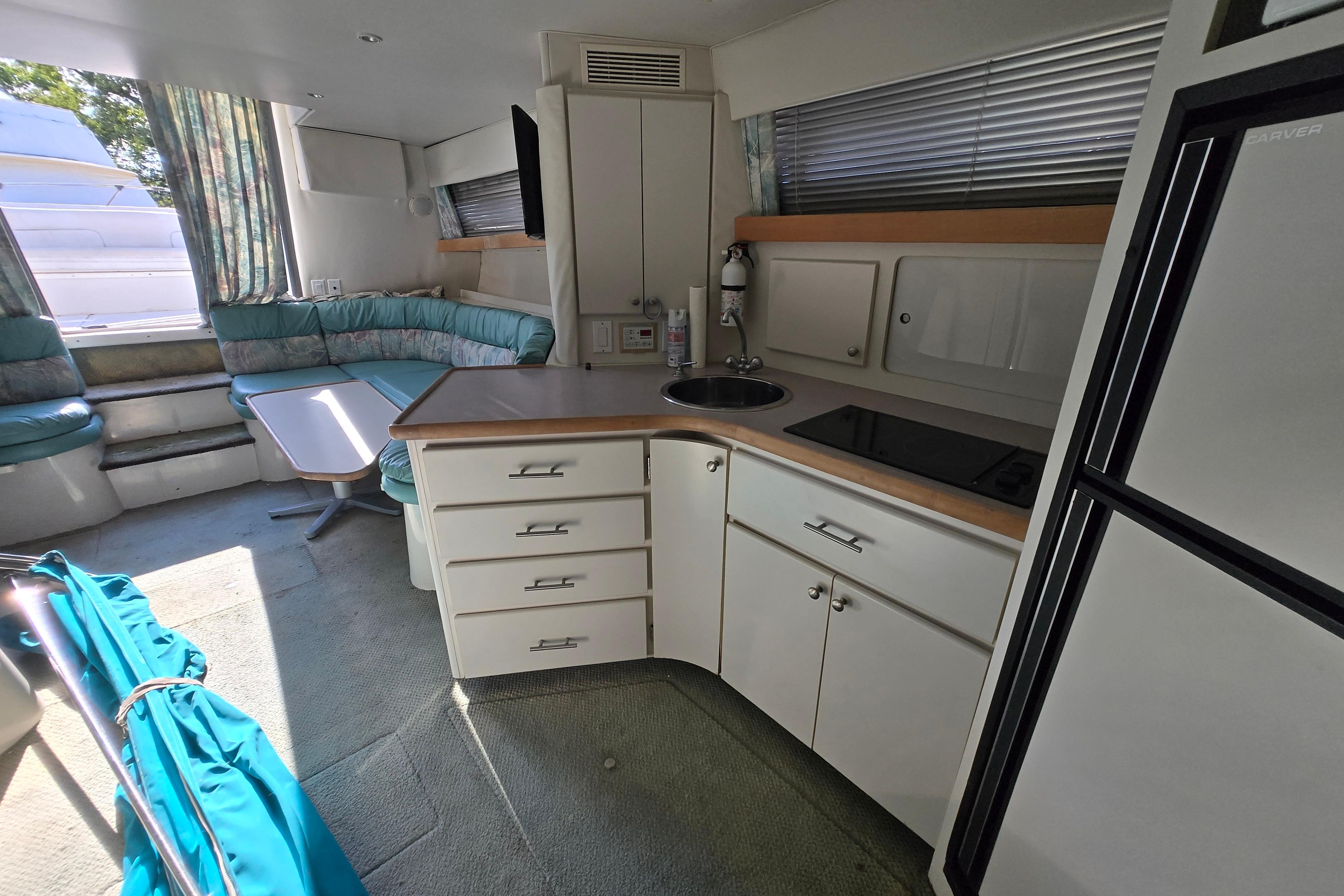 Interior of 1994 Carver 380 Santego yacht with kitchenette and seating area.