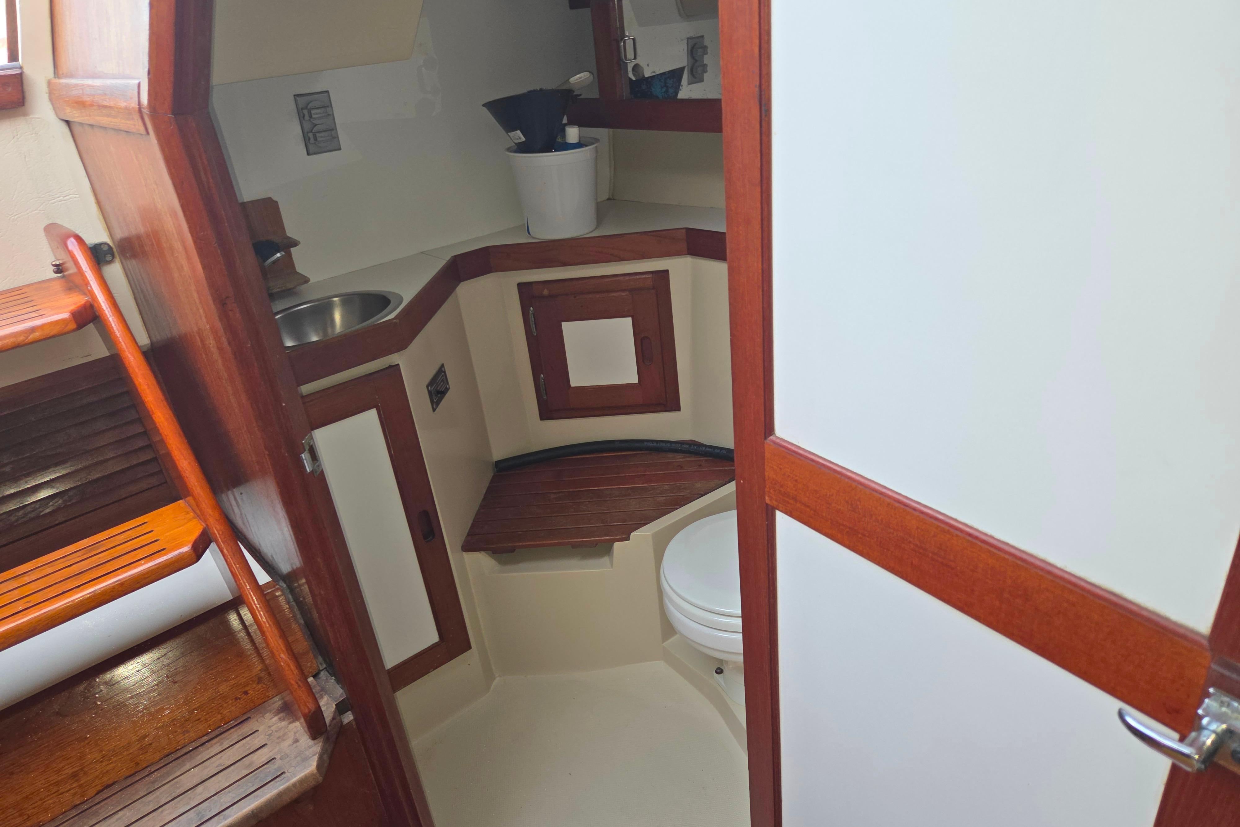 Interior of 1986 Catalina 355 sailboat bathroom with wooden accents and compact design.