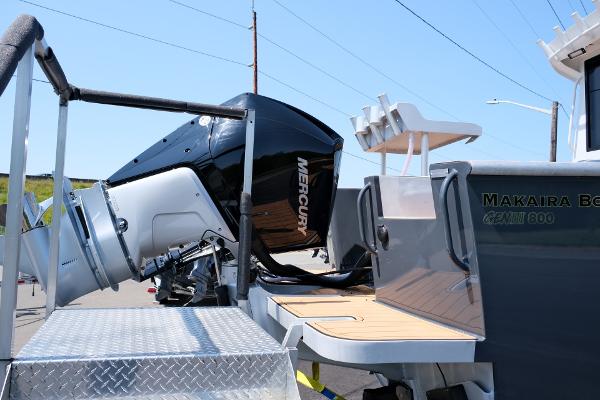 2023 Makaira Gen3 800 boat with Mercury outboard motor, docked on a sunny day.
