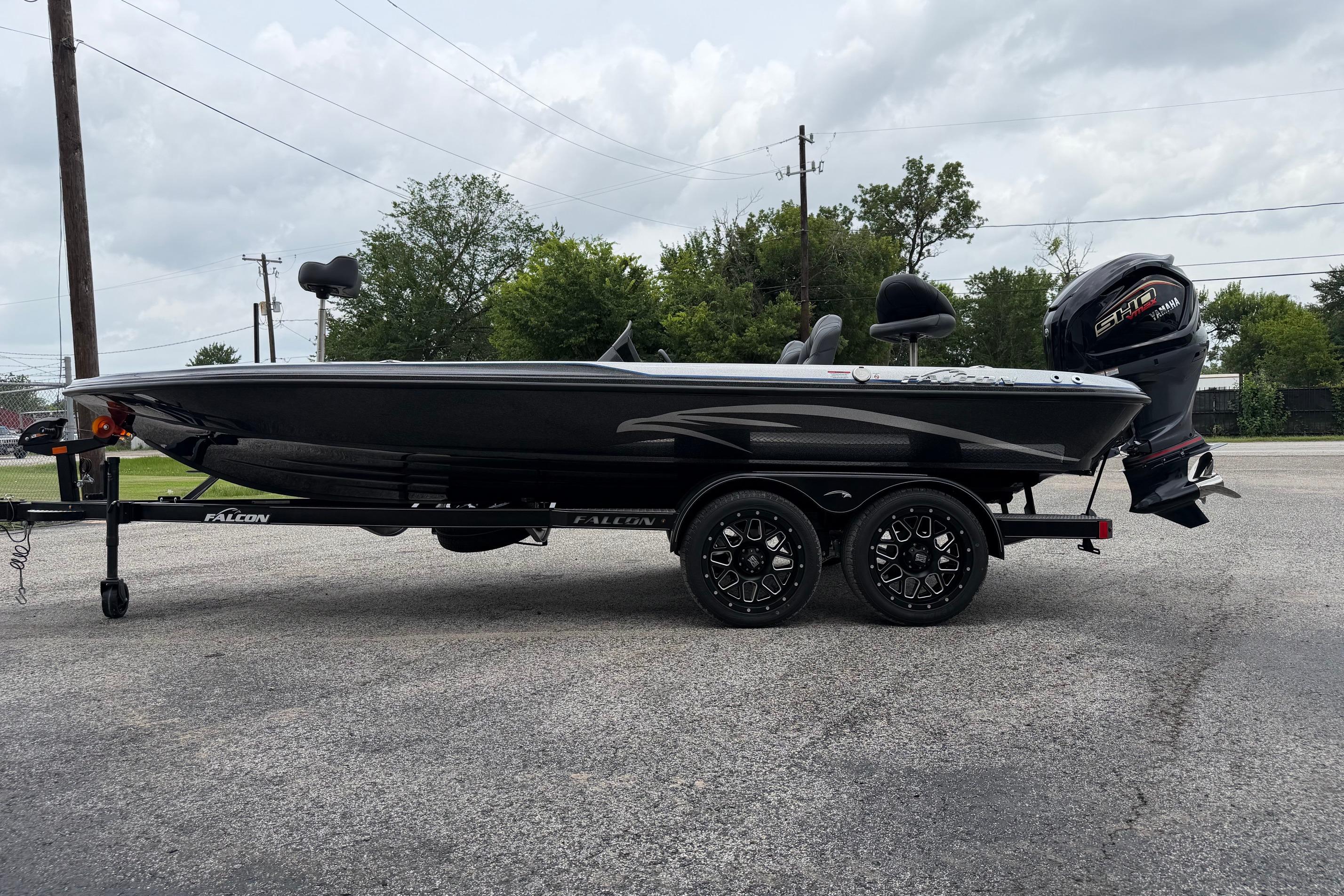 2027 Falcon F20 PREDATOR boat on trailer, parked outdoors under cloudy sky.