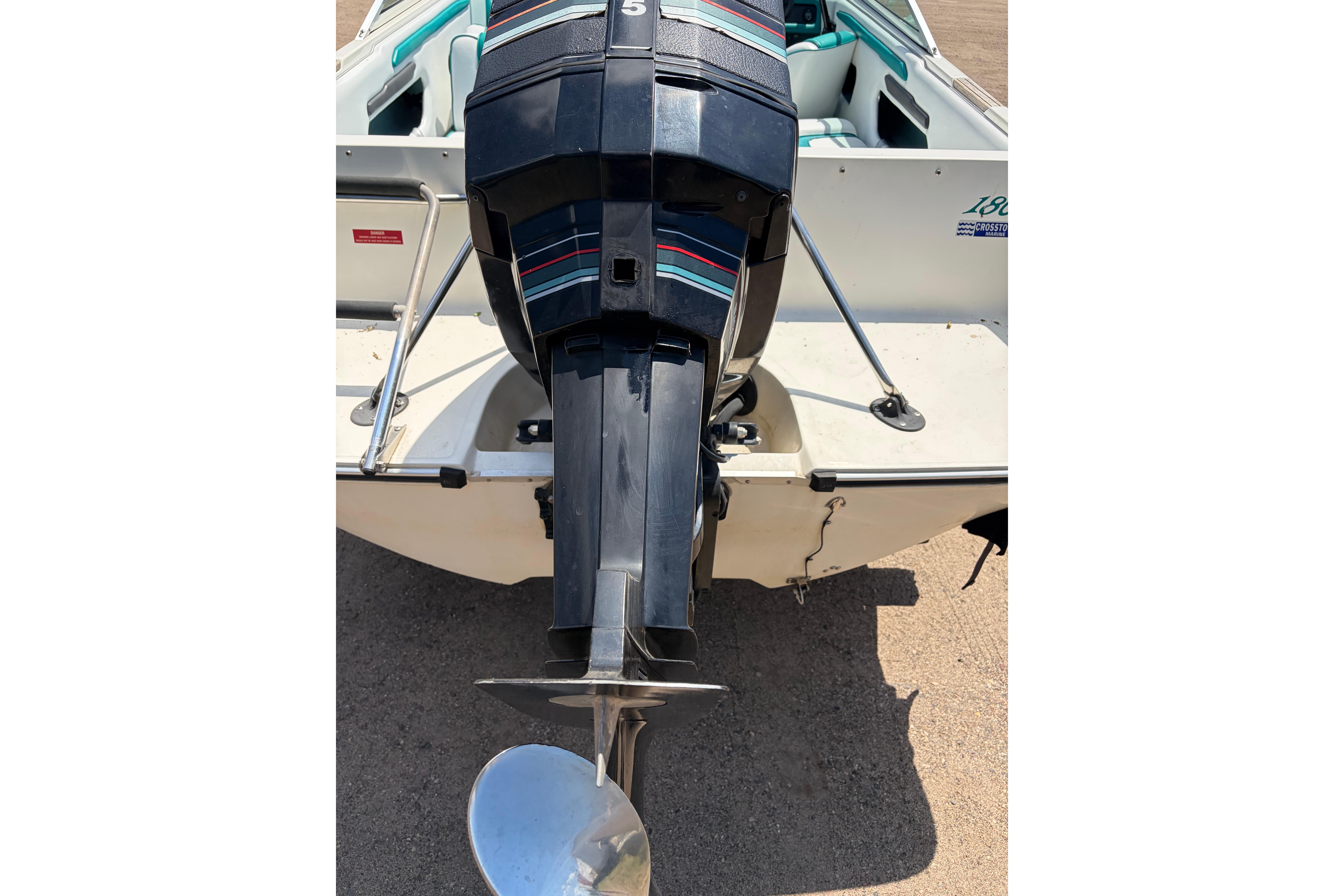 1990 Sea Ray 180 Bow Rider boat with outboard motor, rear view.