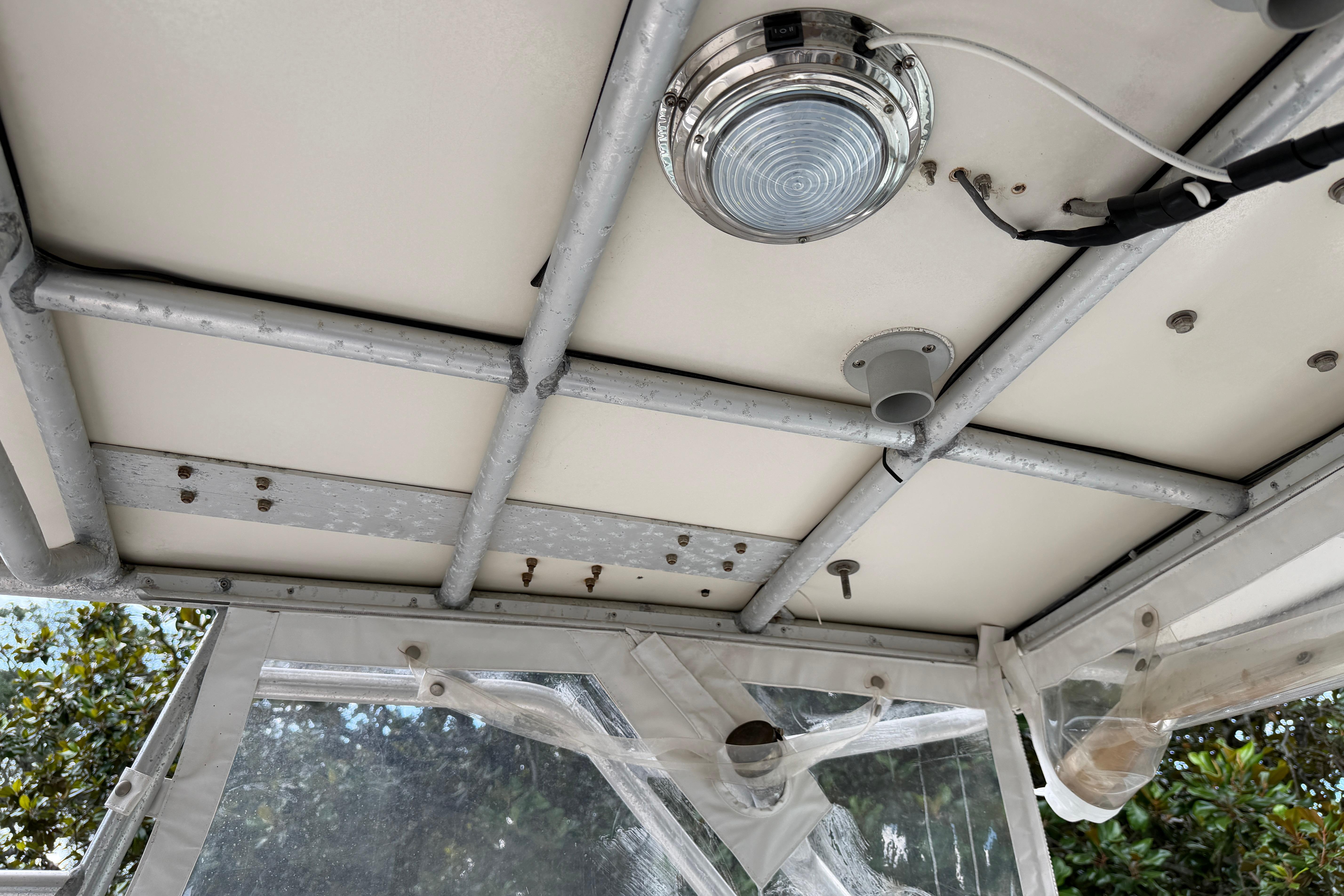 1987 Grady-White Seafarer 226 boat interior roof with light fixture and metal framework.