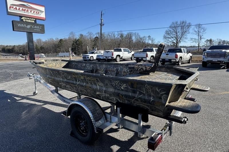 2026 War Eagle 648LDV boat on trailer at dealership parking lot.