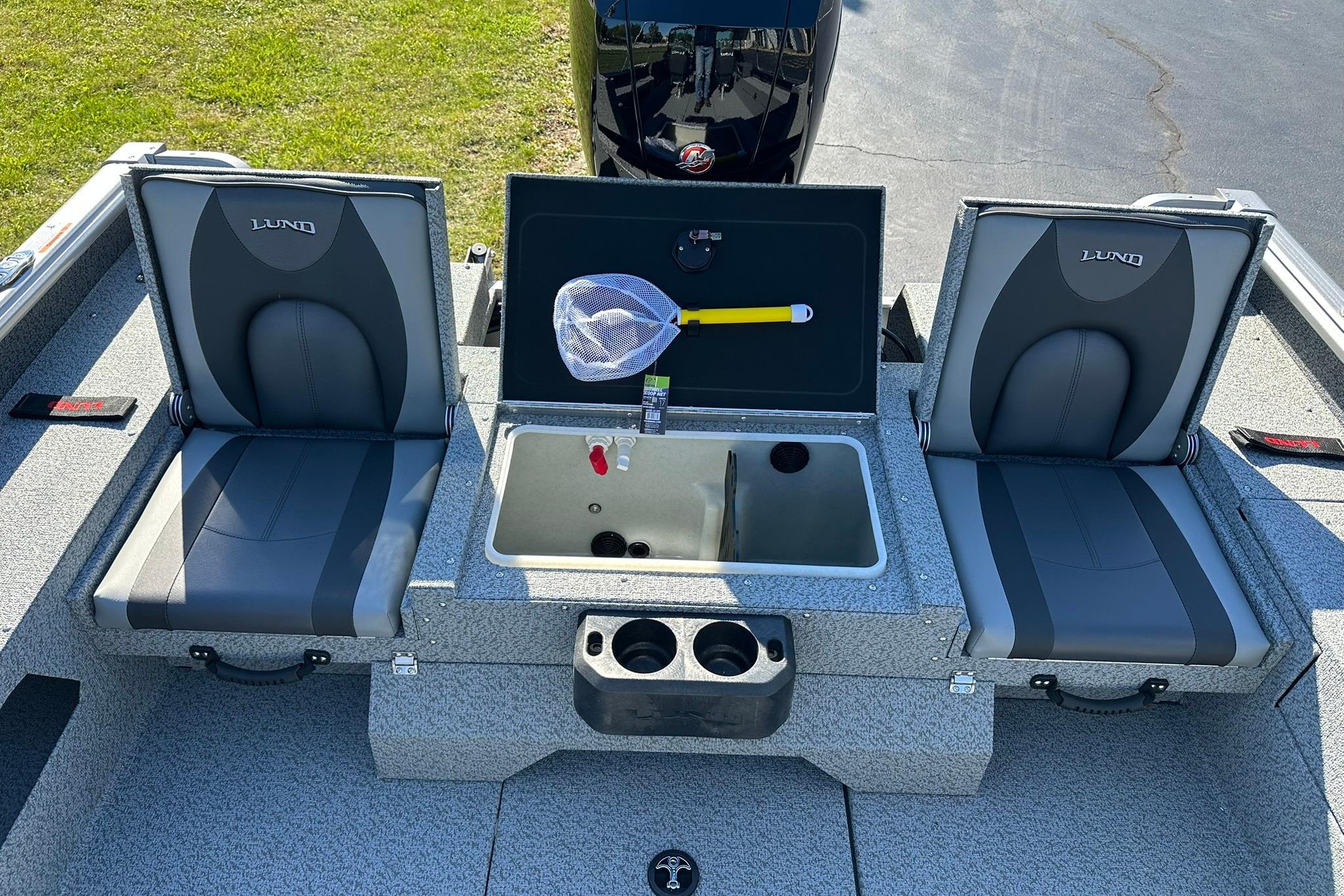 2026 Lund 1875 Impact XS Sport boat interior with seating and storage compartments.