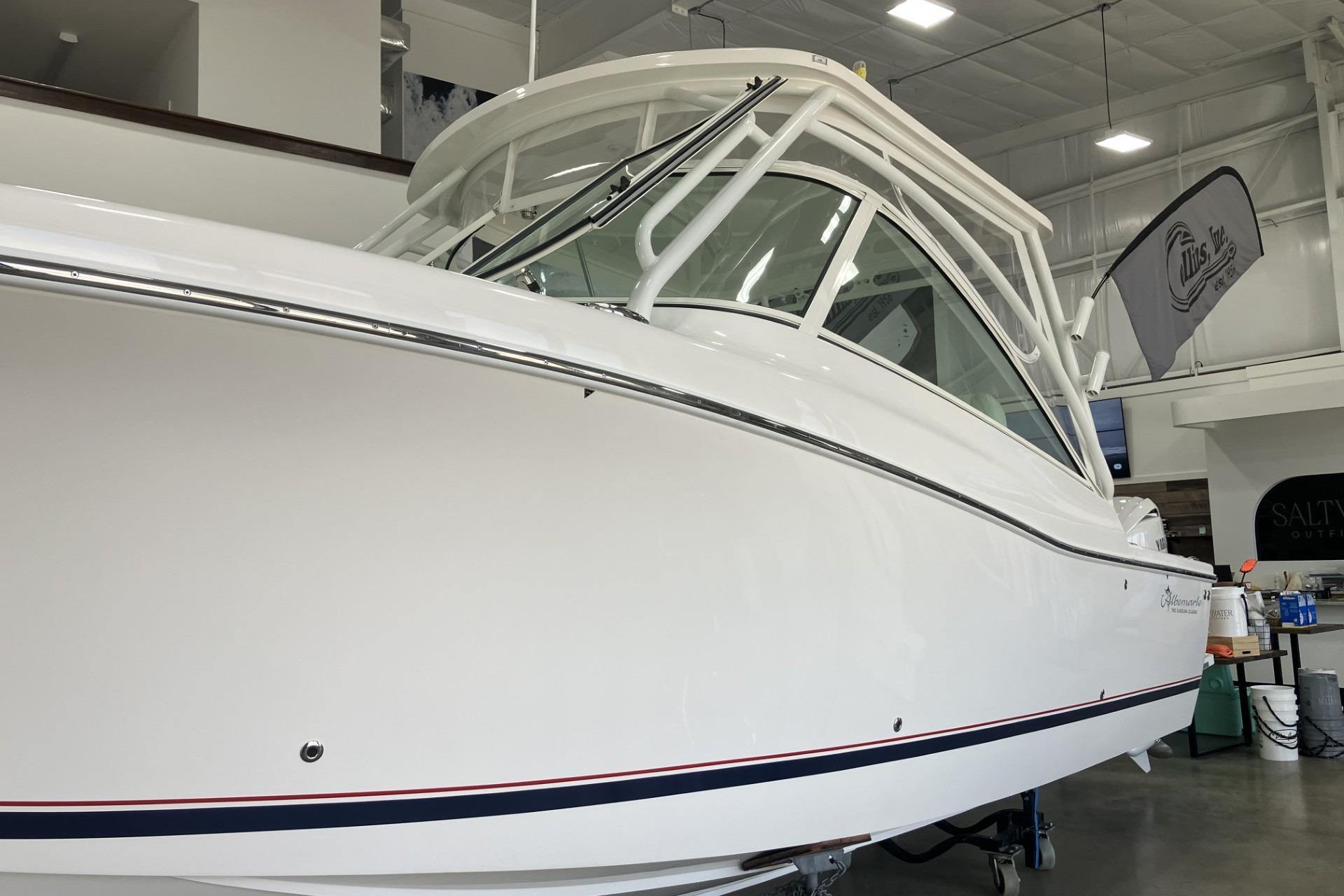 2026 Albemarle 27 Dual Console boat in showroom, showcasing sleek design and modern features.
