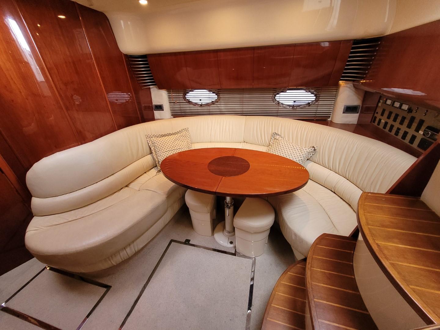 Luxurious interior of 2004 Fairline Targa 43 yacht with elegant seating and wooden table.