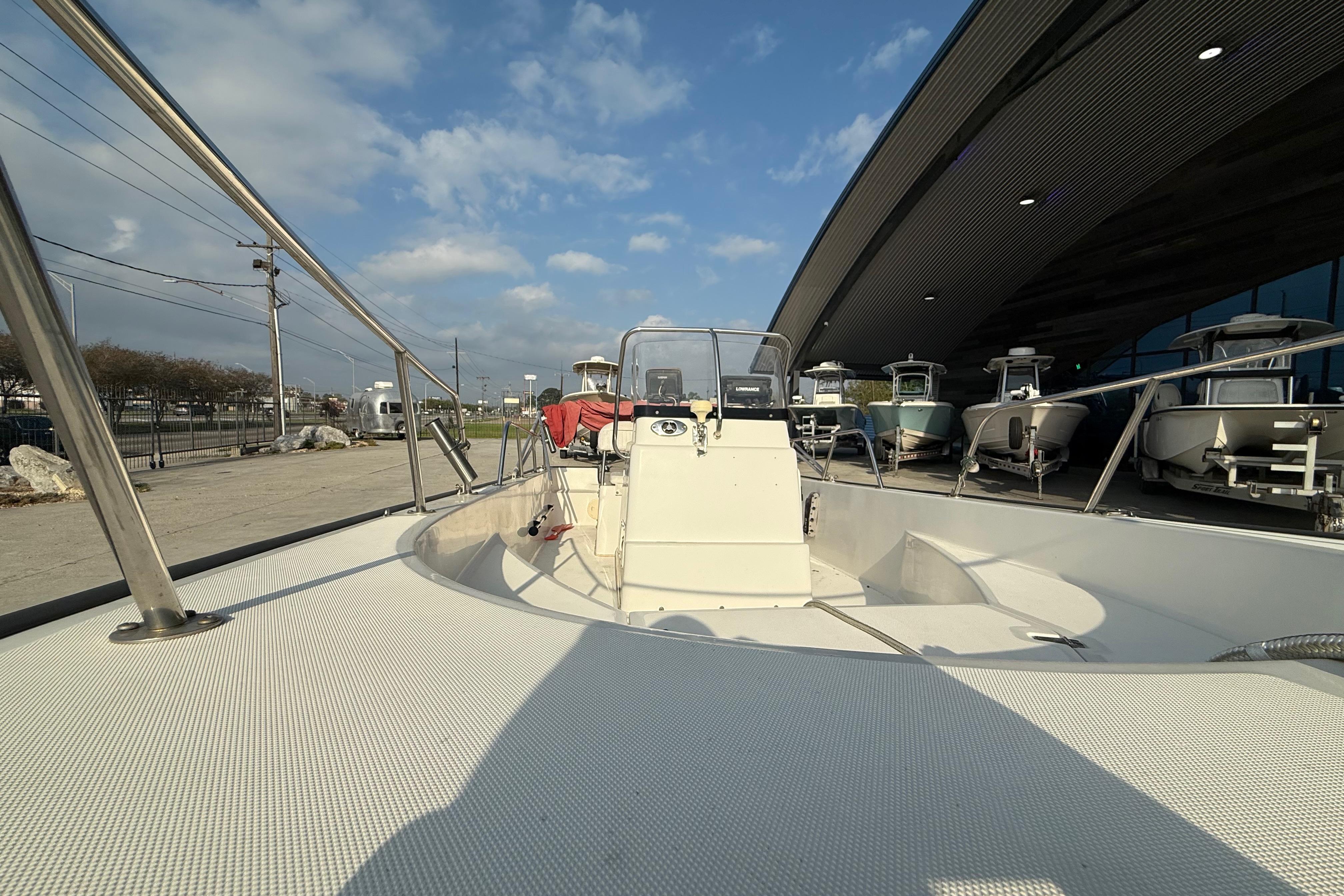 2005 Boston Whaler 17 Montauk boat displayed outdoors under a clear sky.