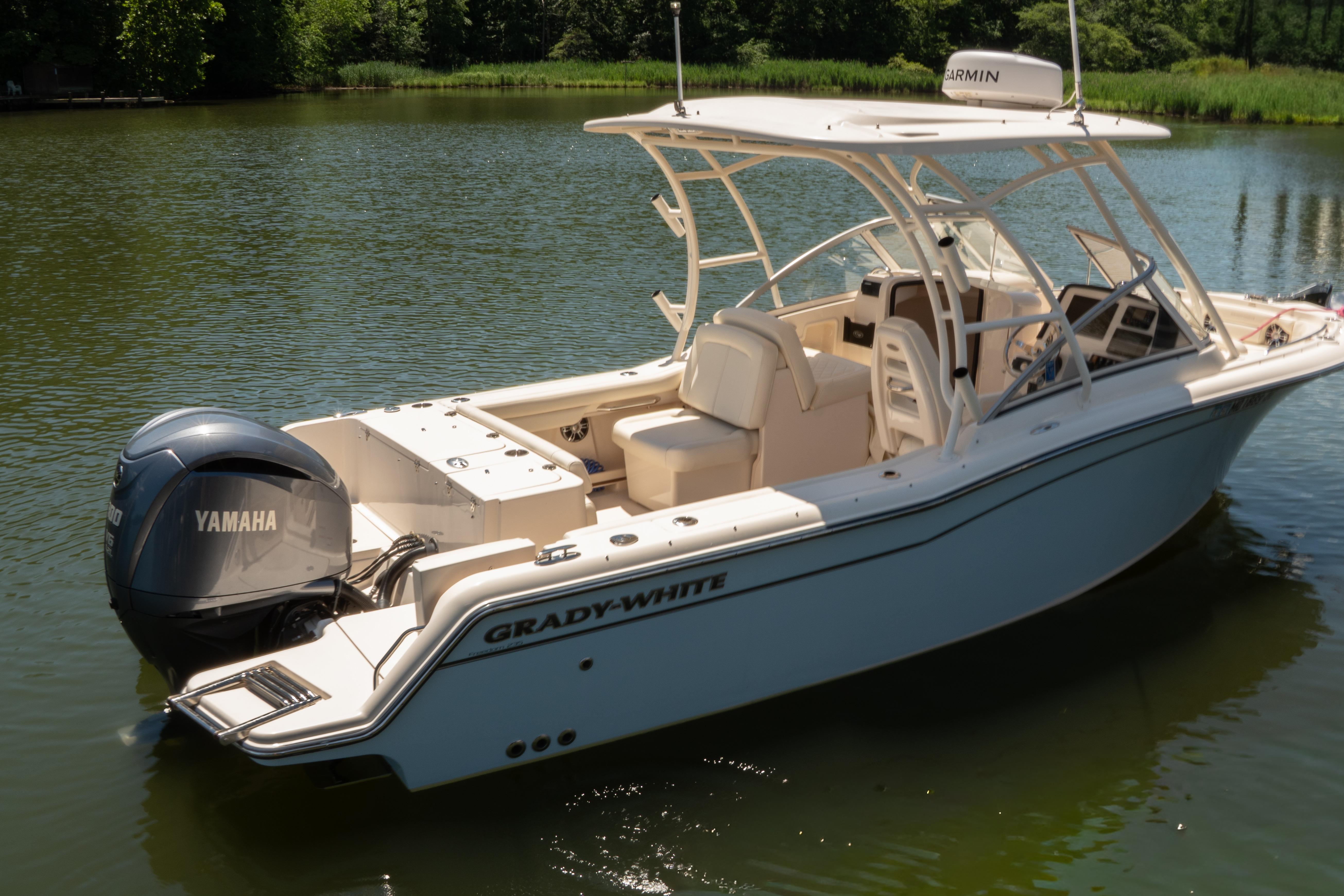 2022 Grady-White Freedom 235 boat with Yamaha engine on calm water.