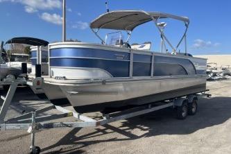 2023 Suntracker G3 Select 322 CC pontoon boat on trailer under clear blue sky.