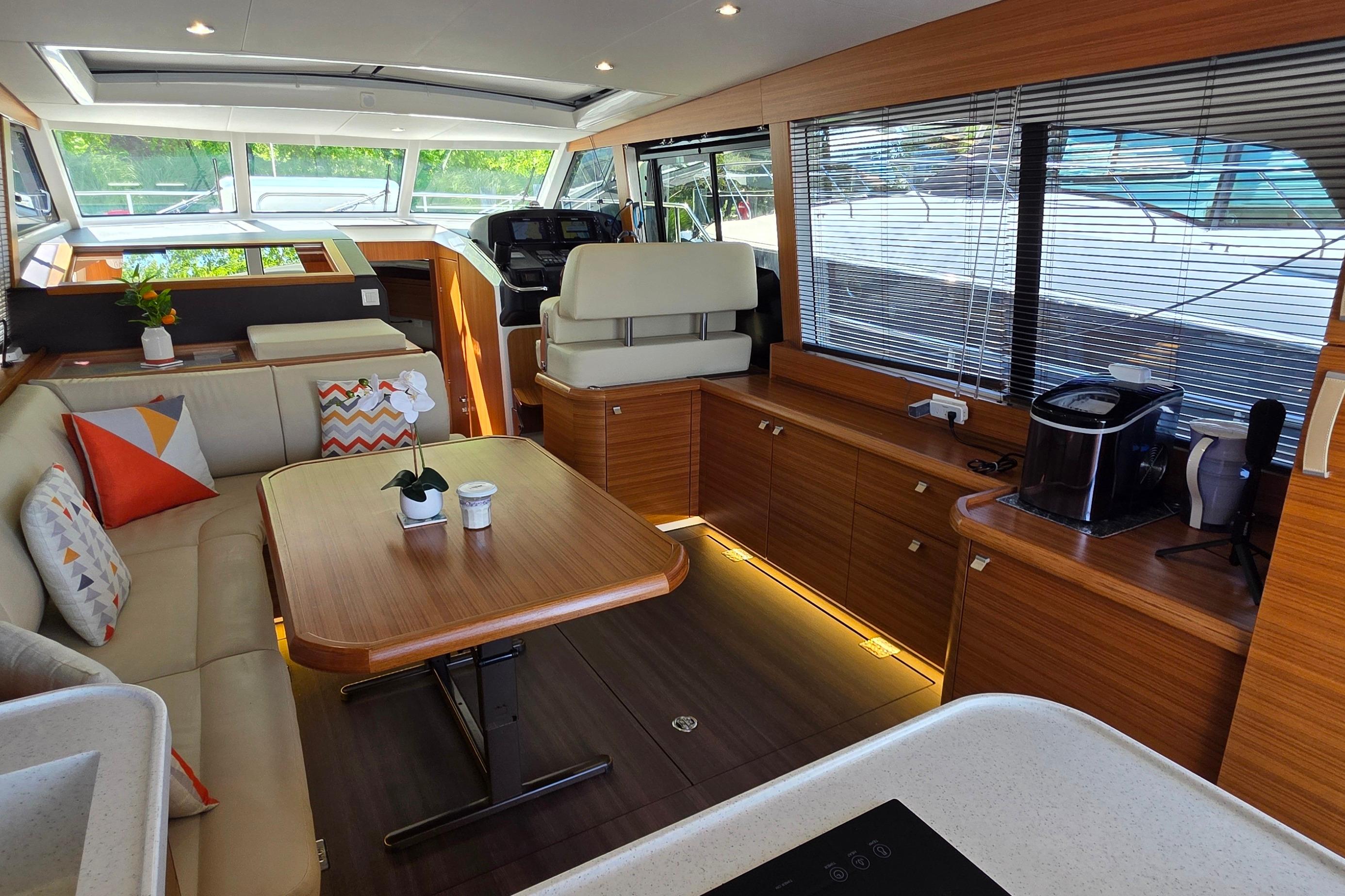 Luxurious interior of 2023 Greenline 40 yacht with modern furnishings and natural light.