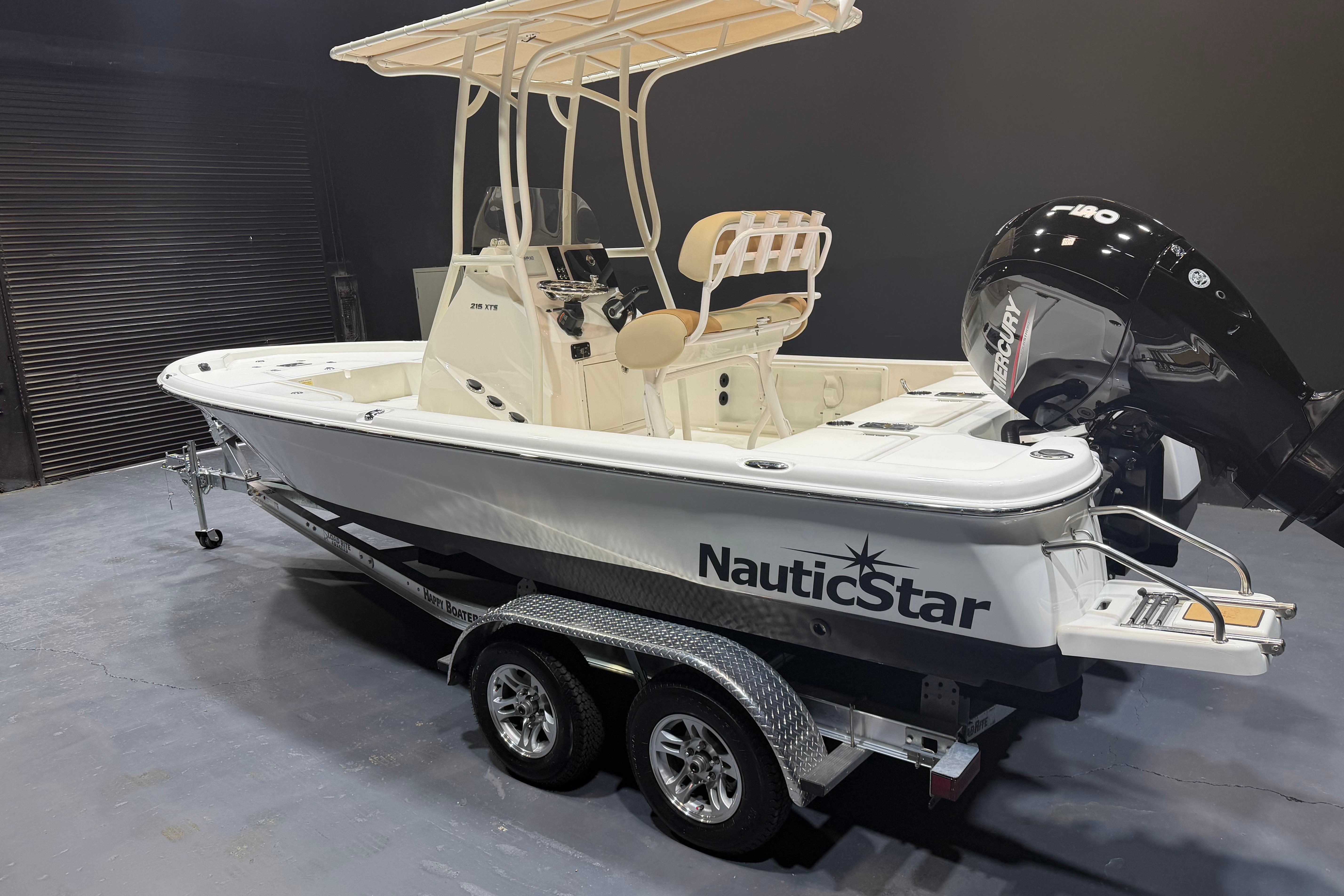 2023 NauticStar 215 XTS boat on trailer, featuring a sleek design and powerful Mercury engine.