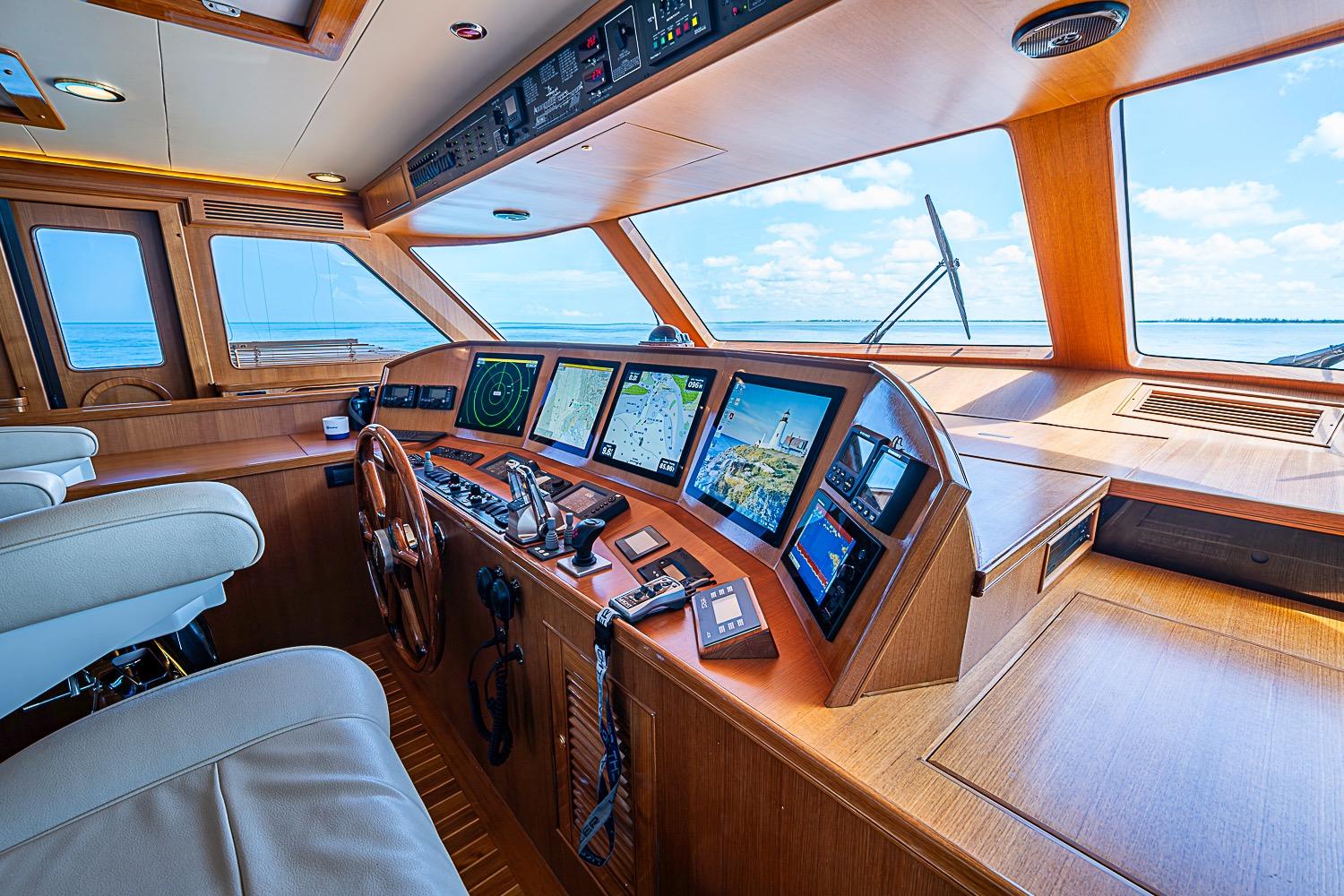 Luxurious 2014 Marlow 80 Explorer yacht cockpit with advanced navigation systems and ocean view.