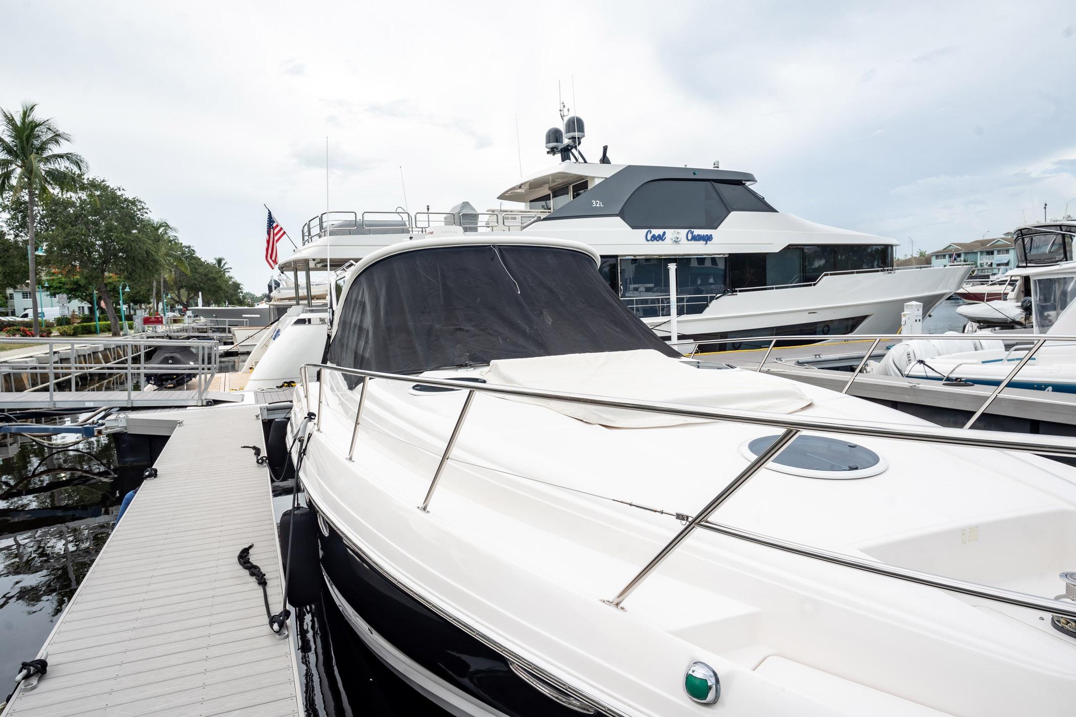 2008 Regal Commodore 4460 yacht docked at marina with American flag in background.