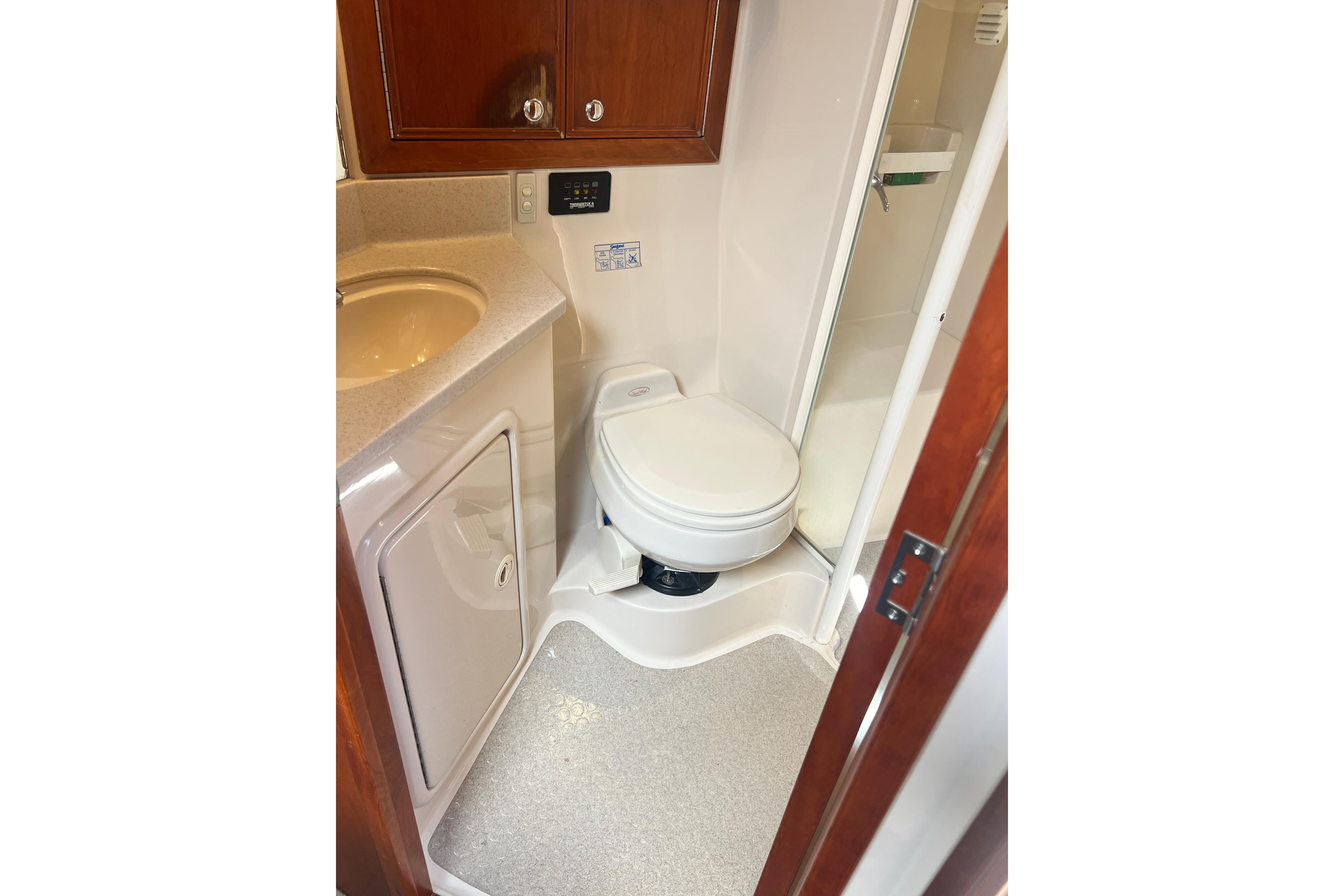 2007 Riviera 33 Flybridge bathroom with toilet, sink, and shower.