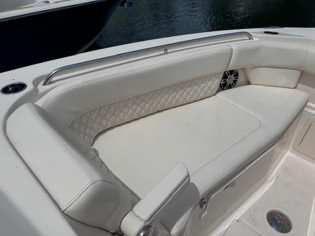 2023 Grady-White Freedom 307 boat with white cushioned seating and diamond-patterned backrest.