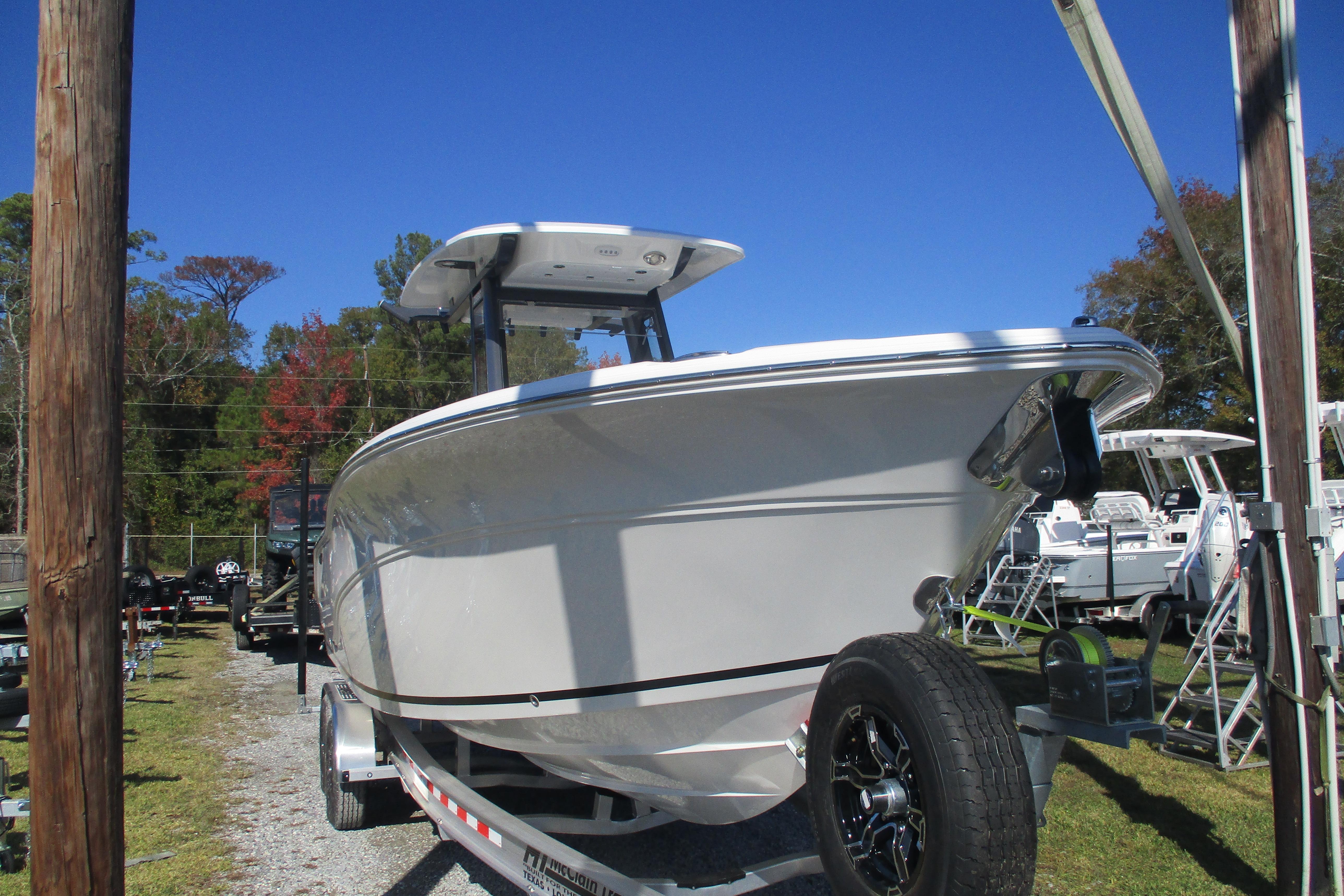 2026 Sea Fox 268 Commander boat on trailer under clear blue sky.