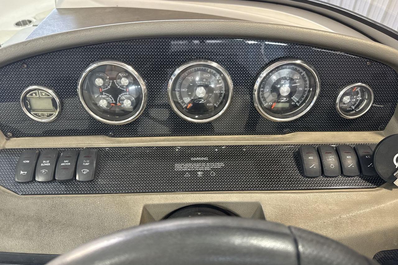 Dashboard of a 2012 Regal 1900 Bowrider boat with gauges and control switches.