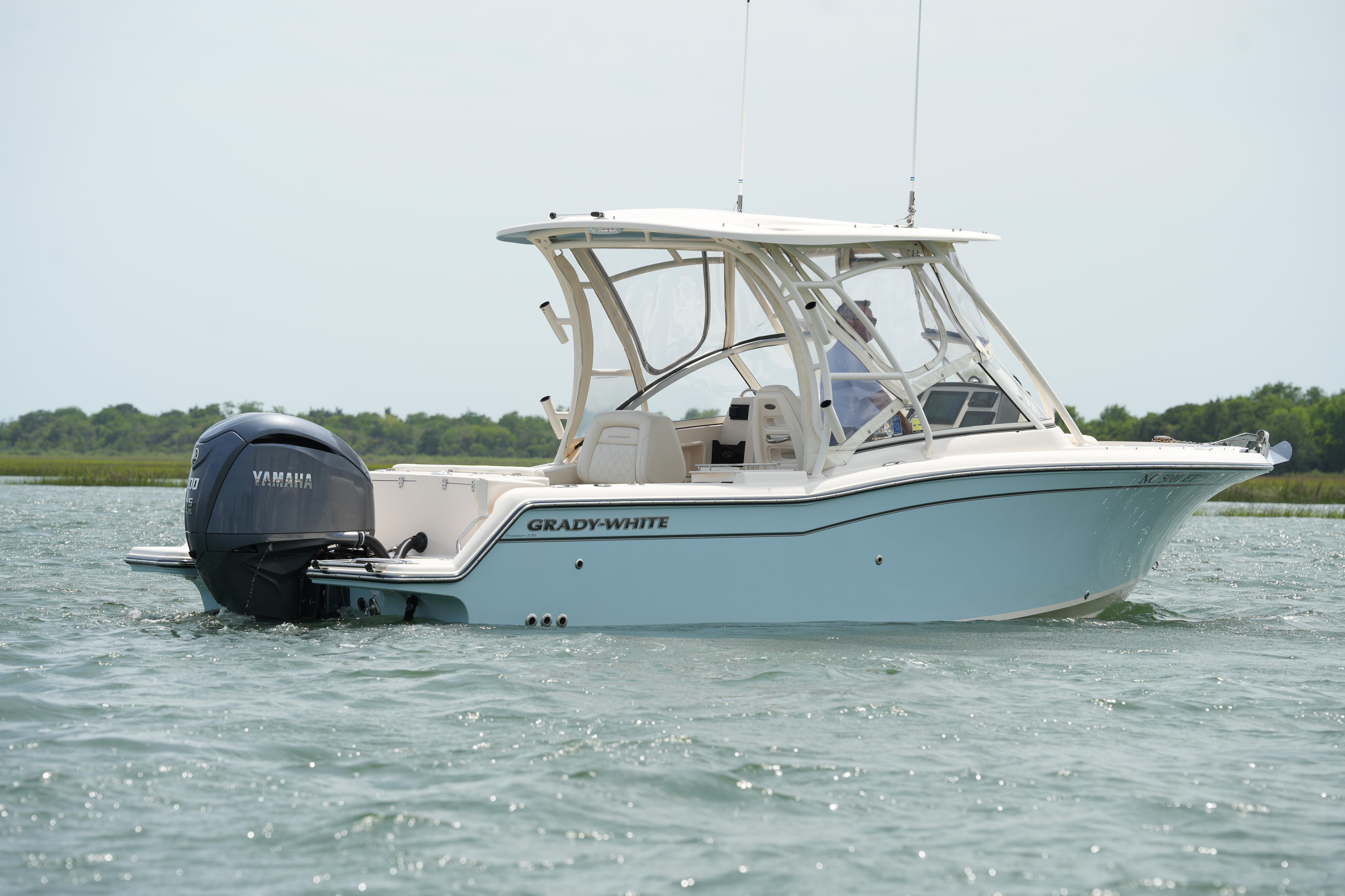 2021 Grady-White Freedom 235 boat on water, featuring Yamaha outboard motor.