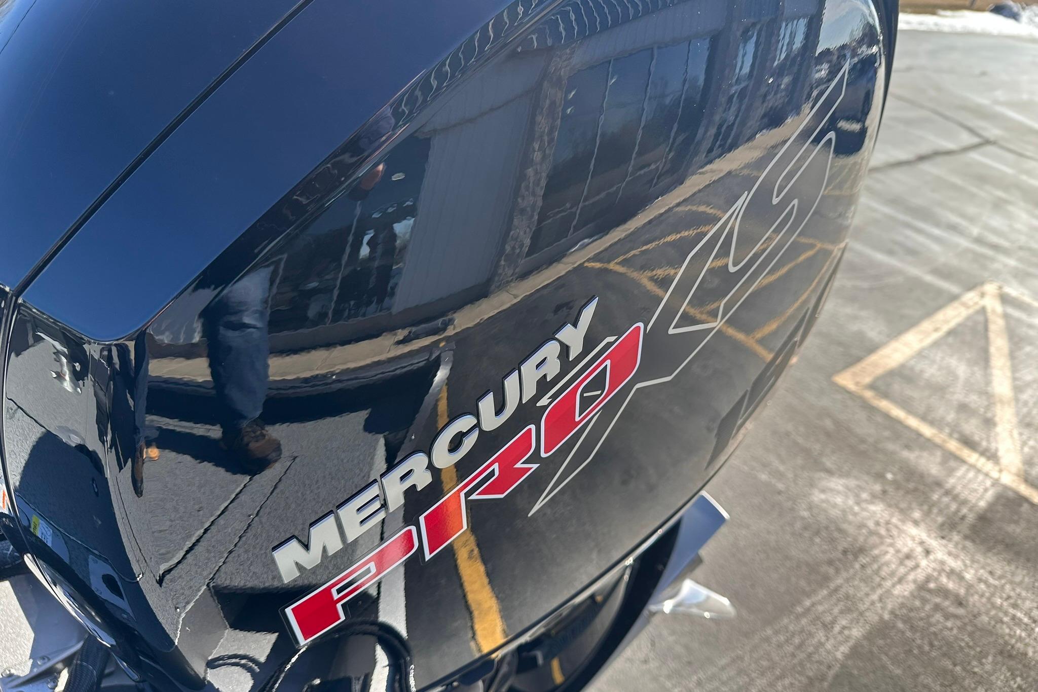 Mercury Pro XS engine on 2026 Lund 1875 Impact XS SS boat, reflecting surroundings.