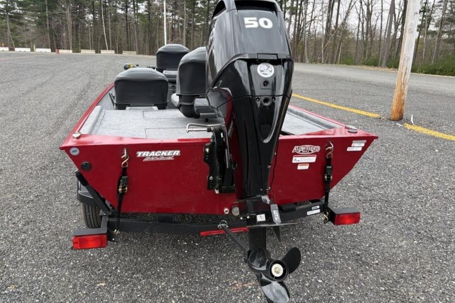 2026 Tracker Bass Tracker Classic XL boat with a 50 HP motor, parked on gravel.