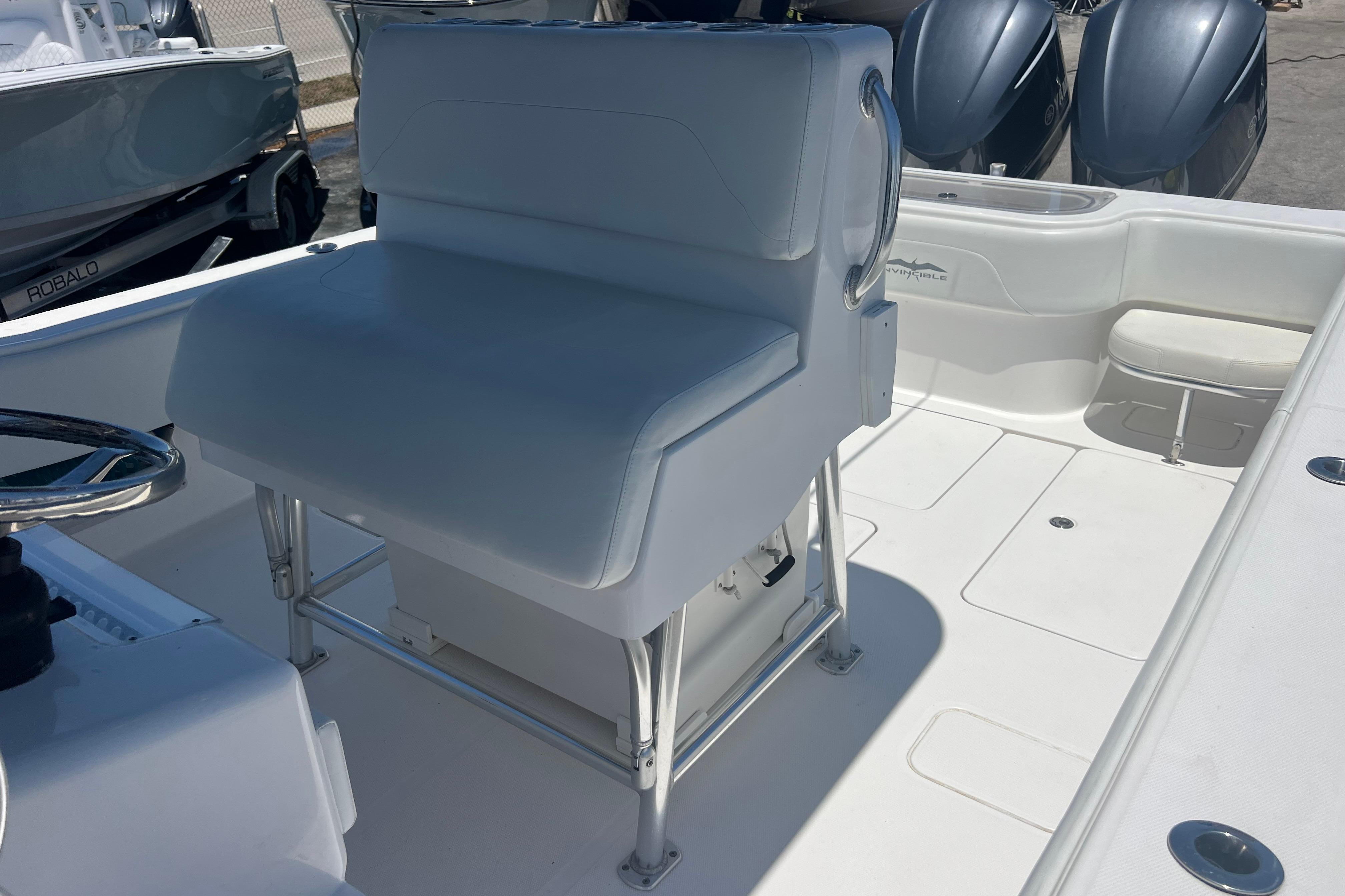 2012 Invincible 33 Open Fisherman boat interior with white seating and steering wheel.
