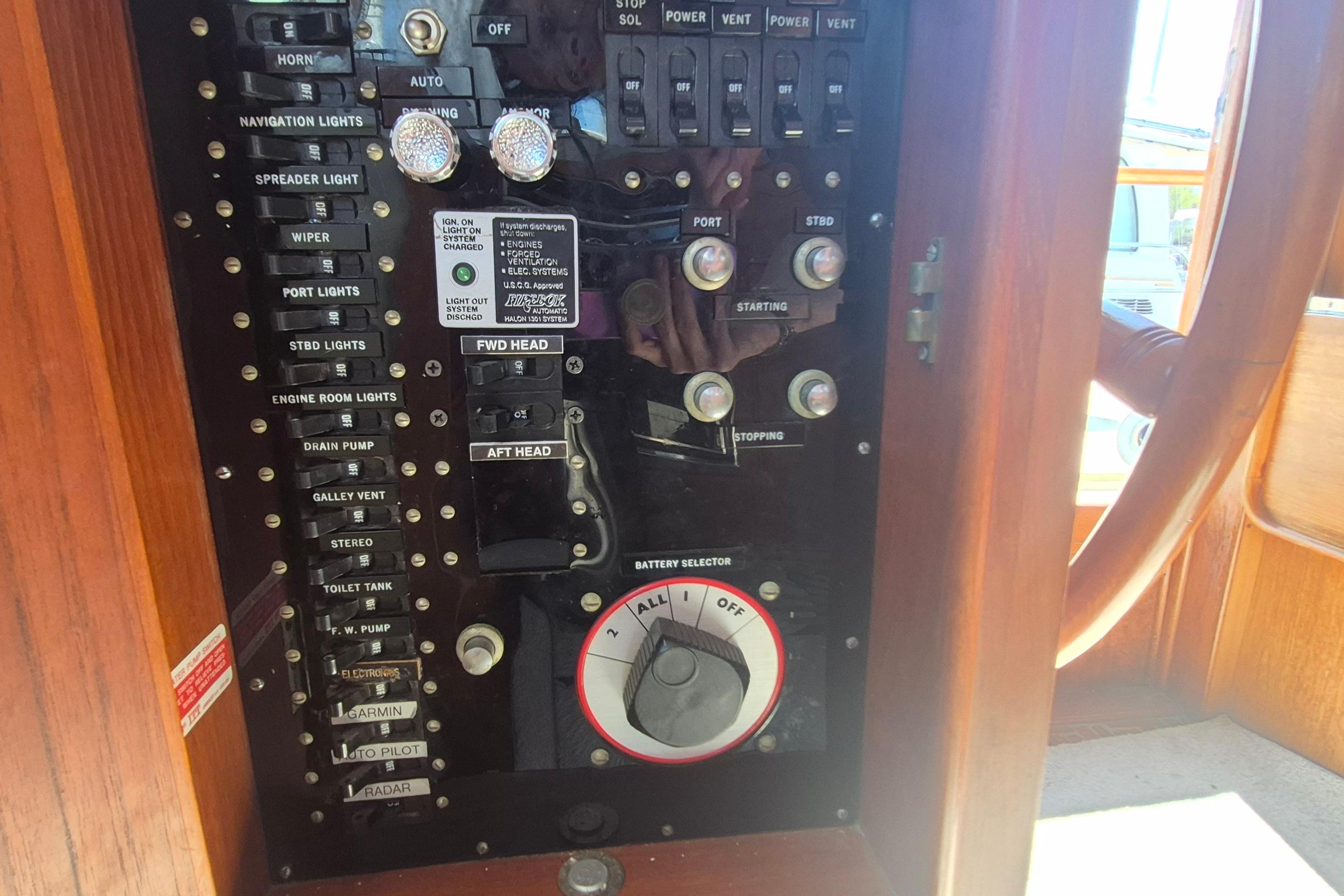 Control panel of a 1983 Grand Banks 42 Motoryacht with various switches and dials.