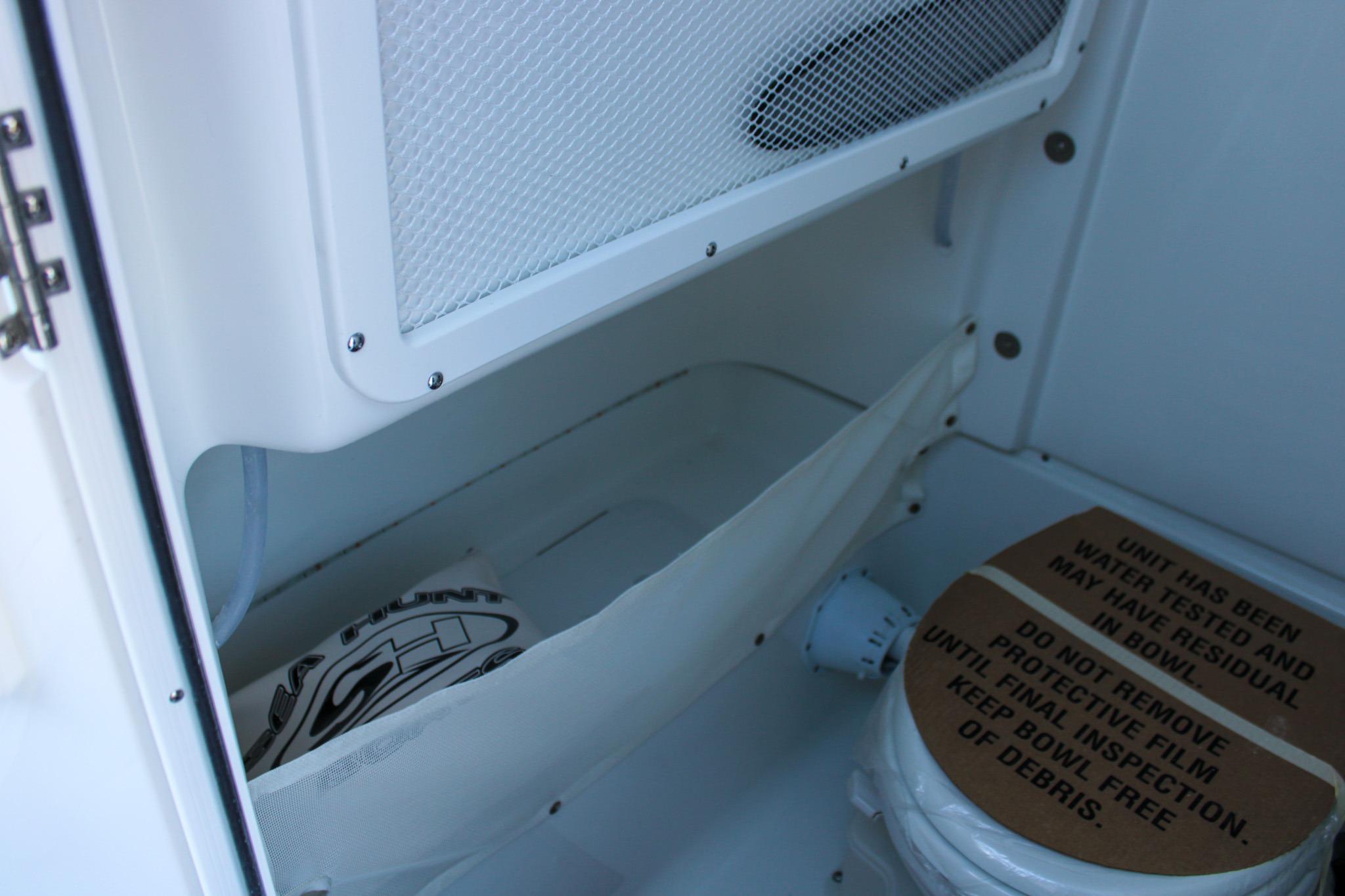 Interior storage compartment of 2026 Sea Hunt Gamefish 25 boat with protective cover.