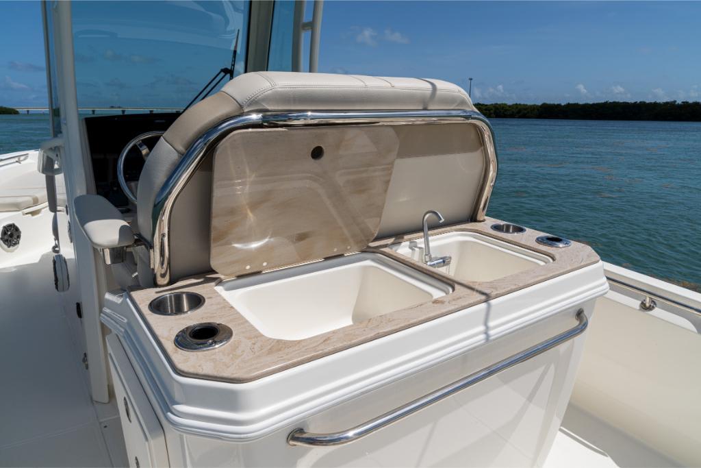 2024 Boston Whaler 280 Dauntless boat interior with sink and seating.