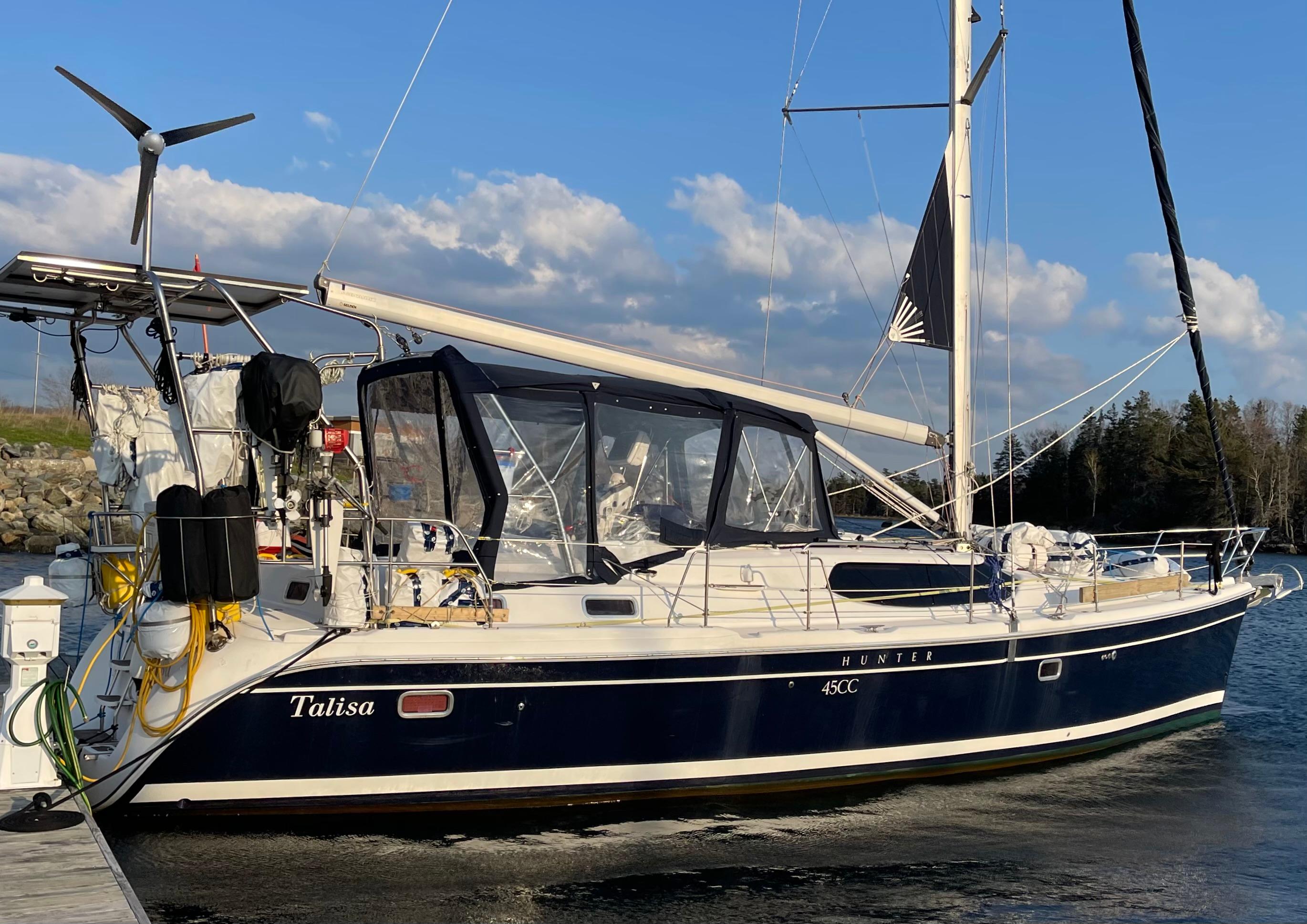2006 Hunter 45cc sailboat docked, featuring a sleek design and blue hull.
