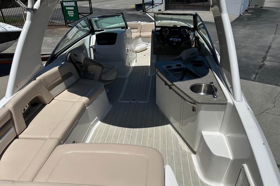 2012 Chaparral 284 Sunesta boat interior with seating and kitchenette.