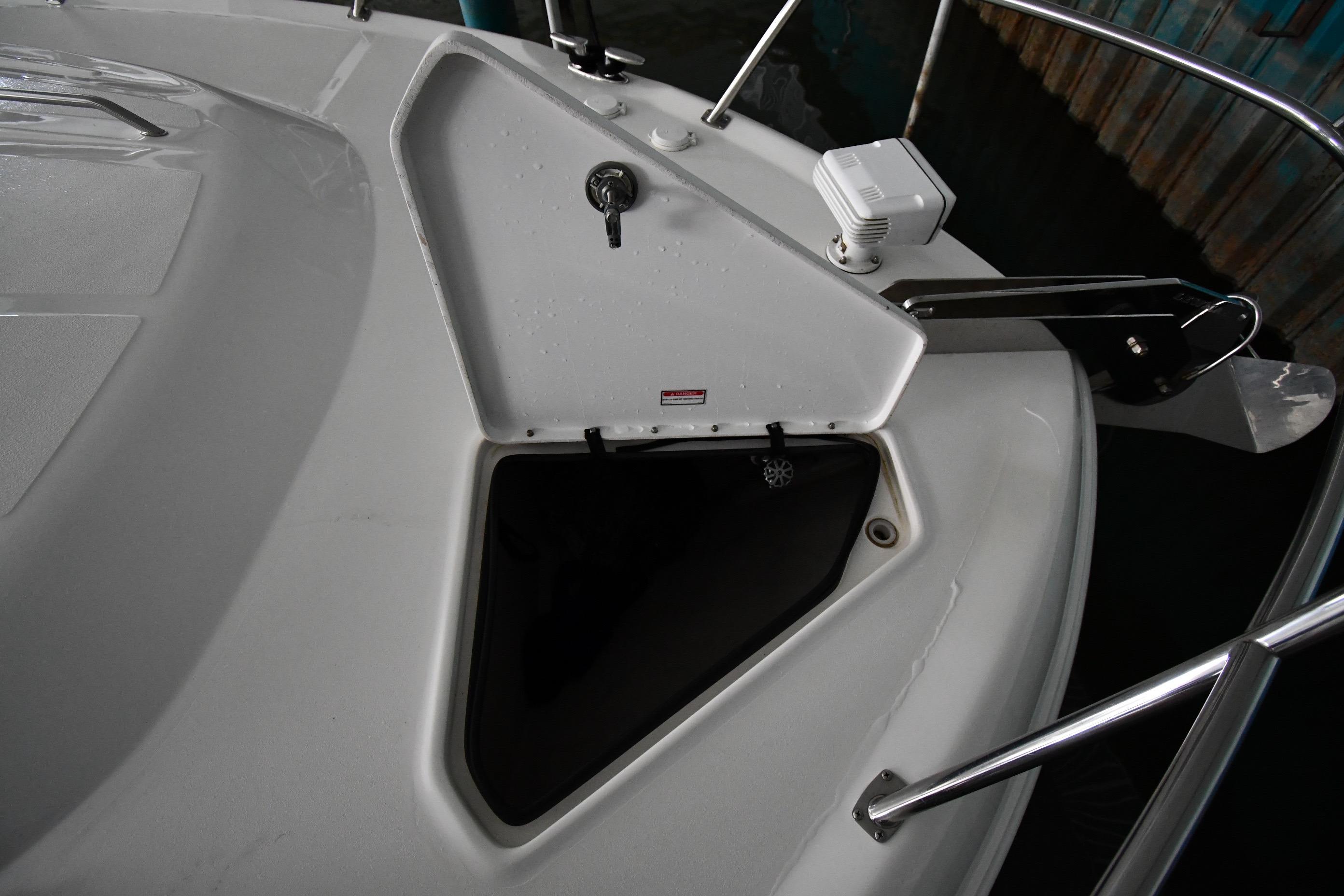 2001 Sea Ray 540 Sundancer boat deck with open storage compartment.