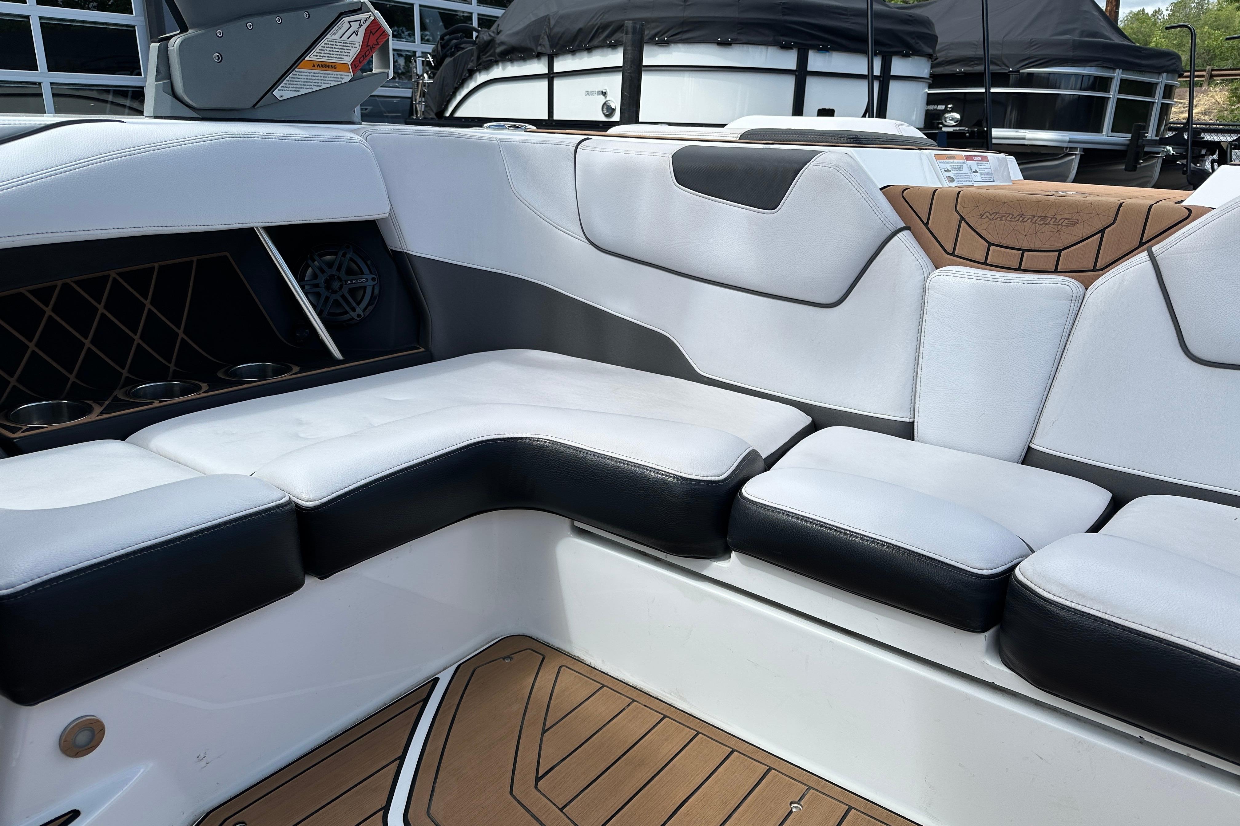 Interior seating of 2017 Nautique Super Air Nautique GS20 boat, featuring white and black upholstery.