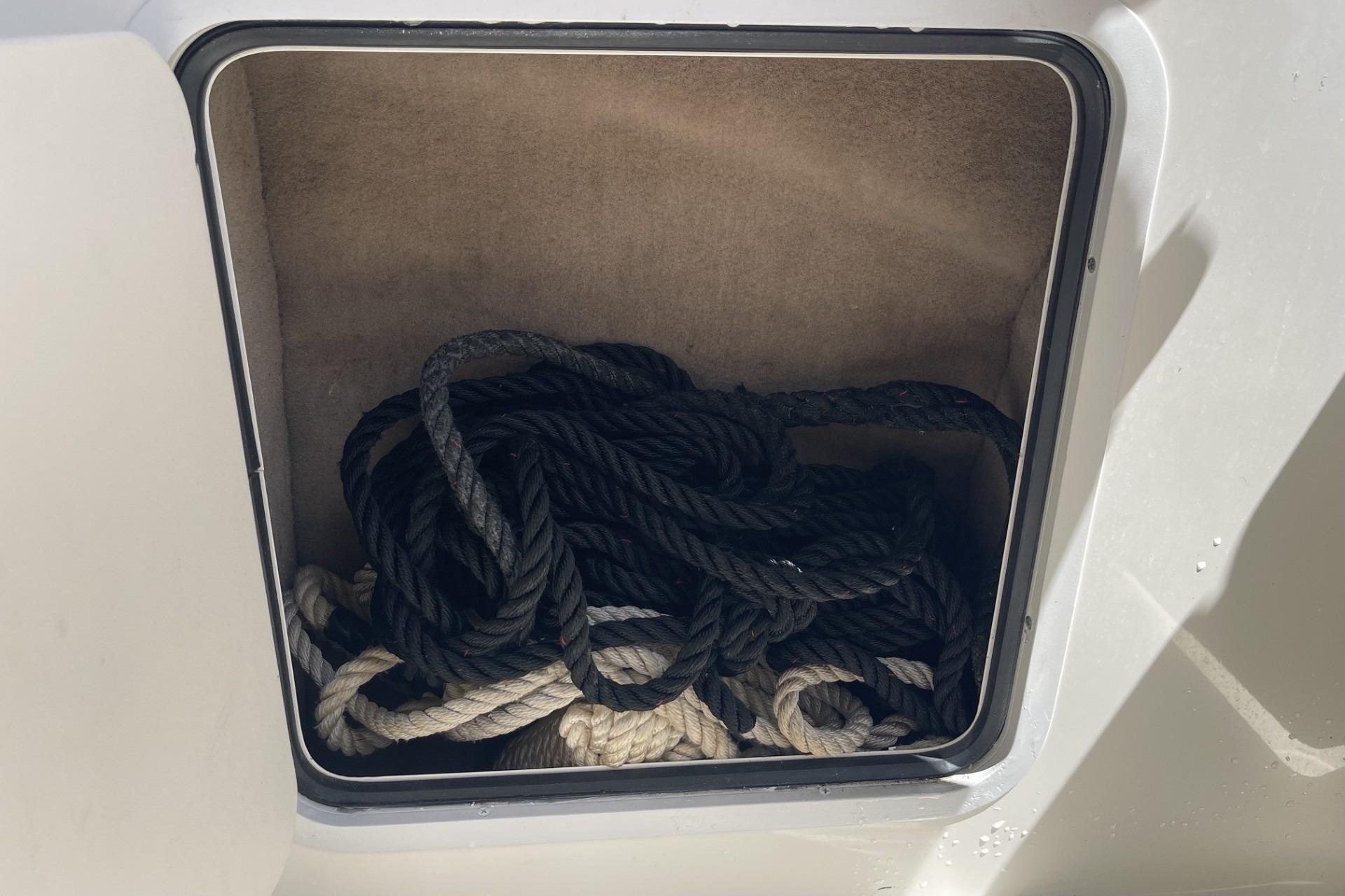 Storage compartment with ropes on a 2000 Sea Ray Sundancer 260 boat.