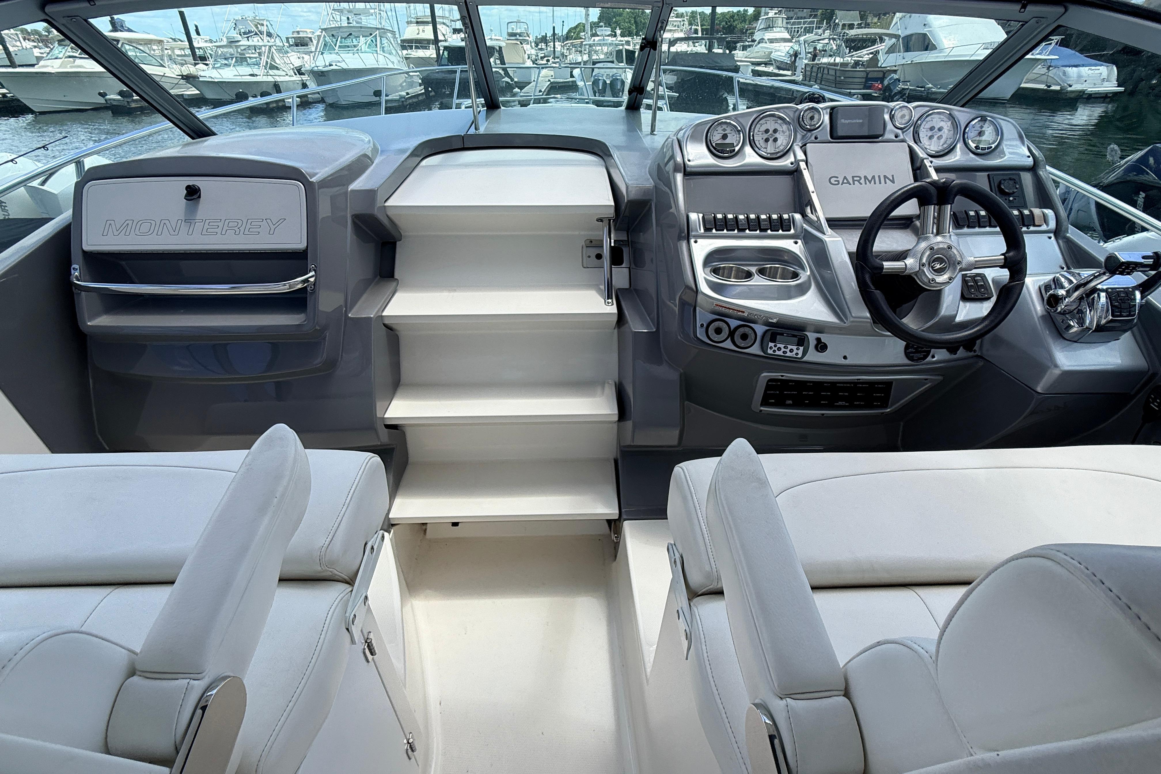 Interior of a 2011 Monterey 320 Sport Yacht with modern dashboard and seating.
