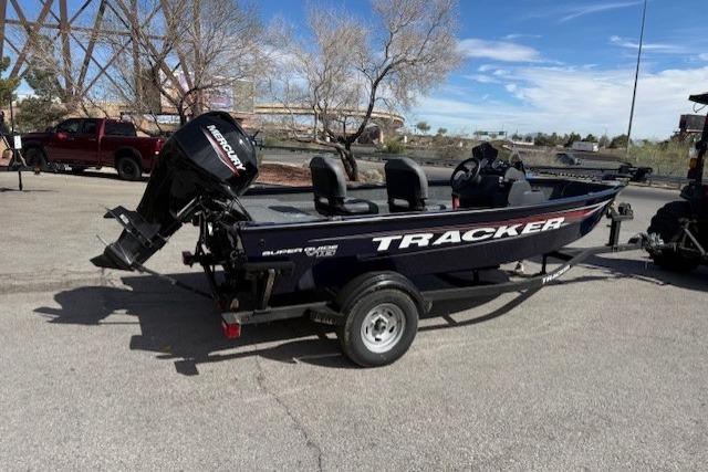 2026 Tracker Super Guide V-16 SC boat on trailer, parked outdoors.