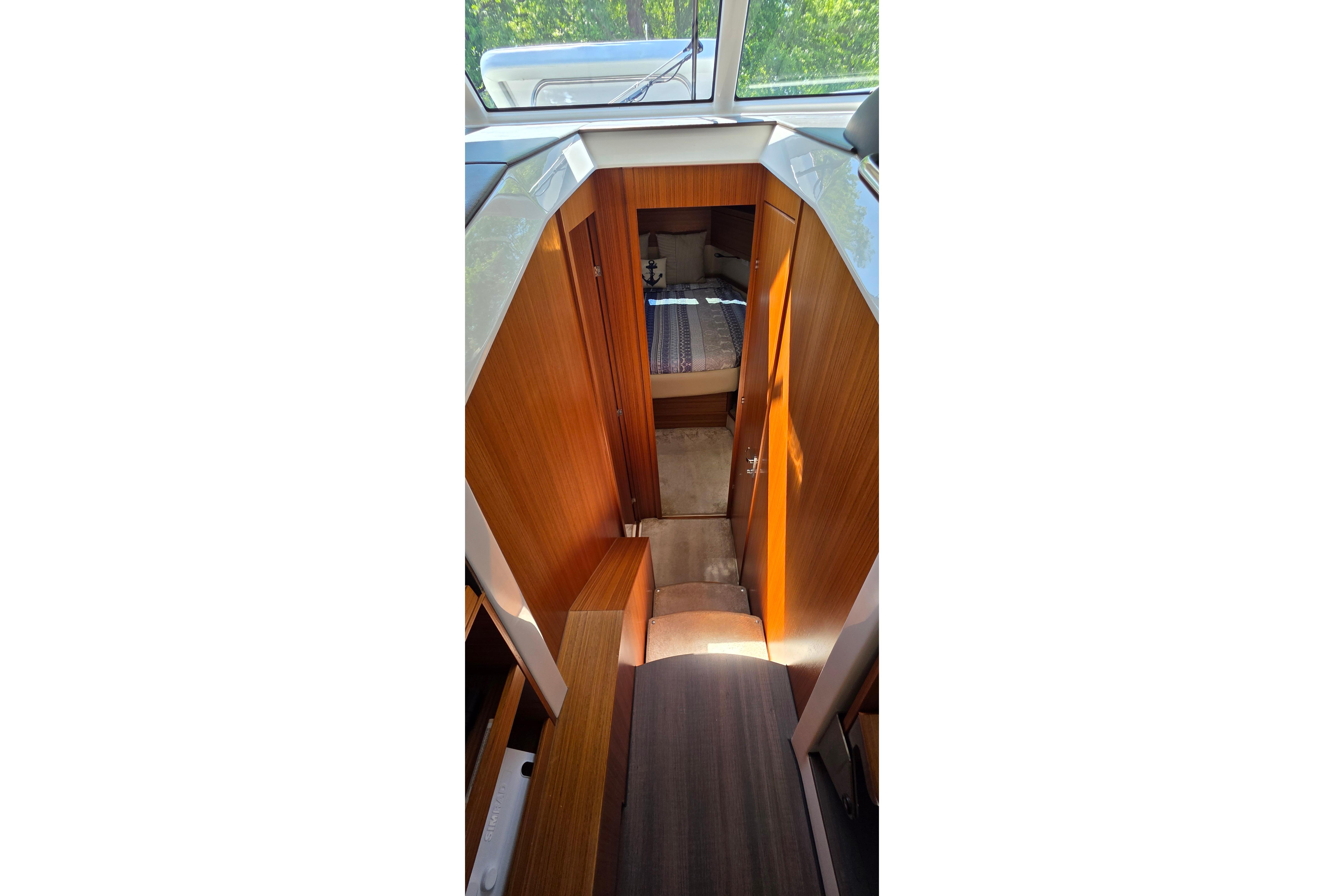 Interior view of 2023 Greenline 40 yacht cabin with wooden finishes.