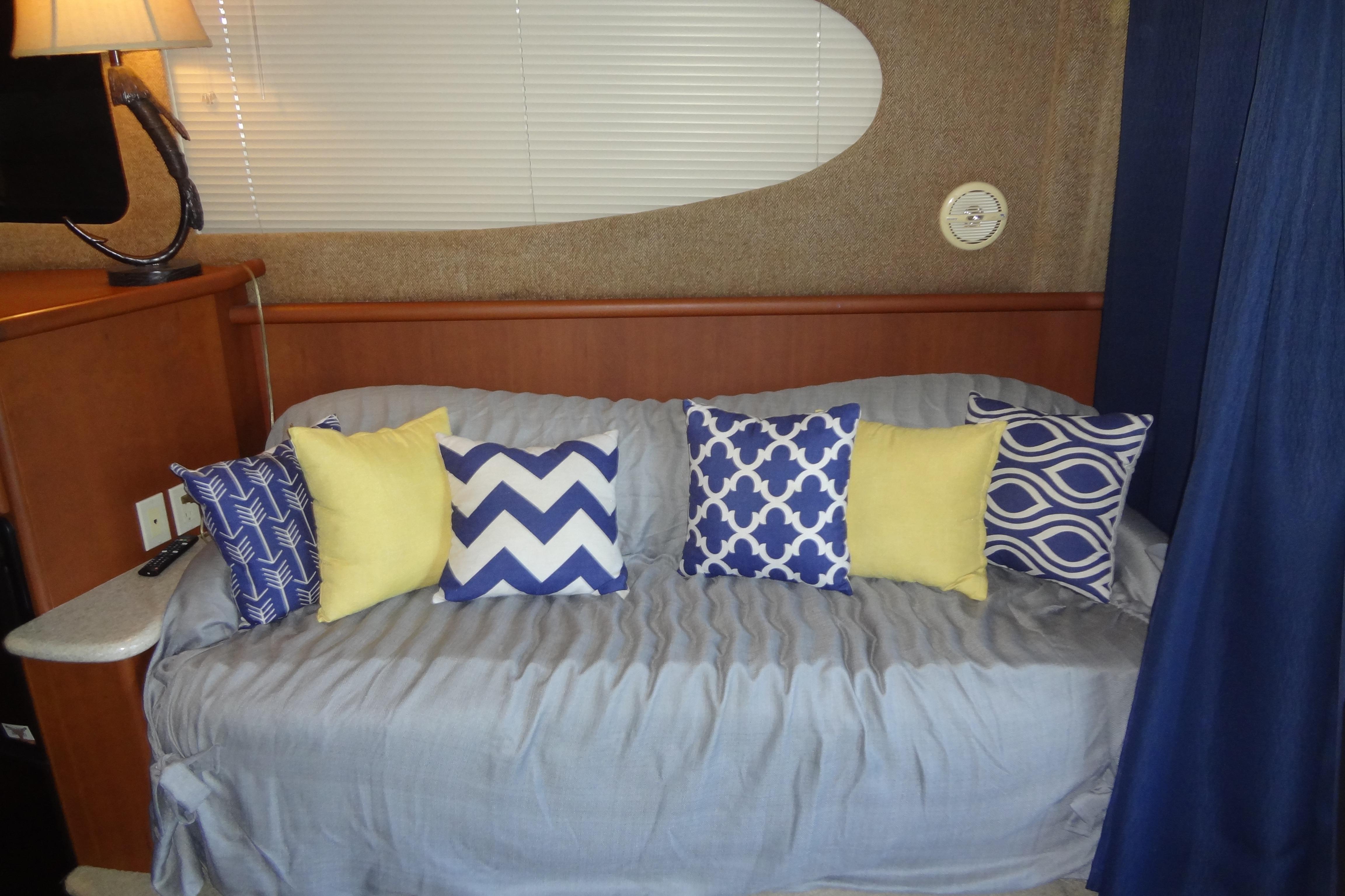 Interior of 2005 Silverton 34 Convertible with decorative pillows on a sofa.
