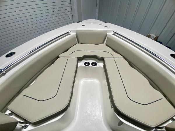 2024 Key West 219 FS boat interior with cushioned seating and stainless steel railings.