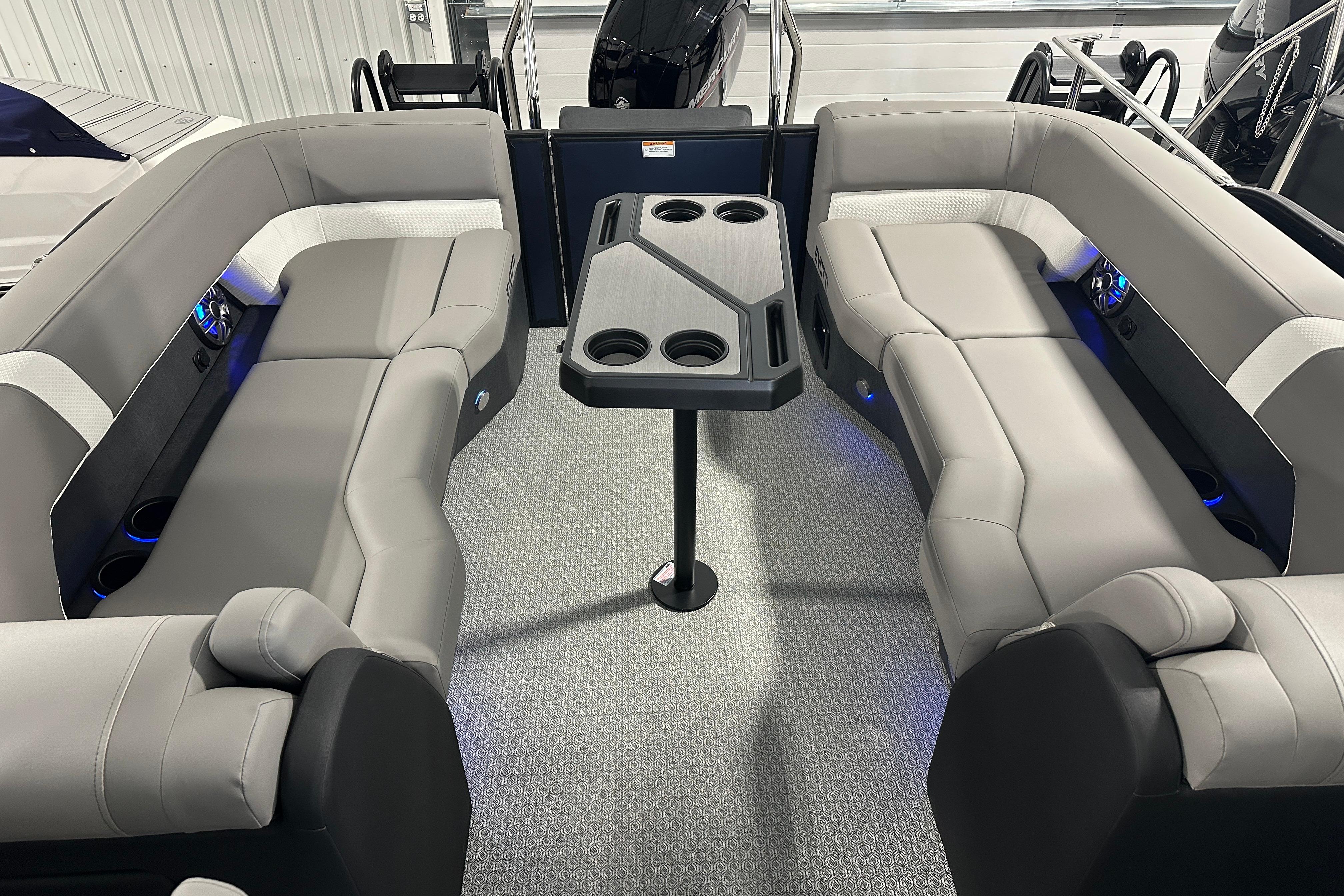 Luxurious interior of 2026 Evotti 523QL boat with plush seating and central table.