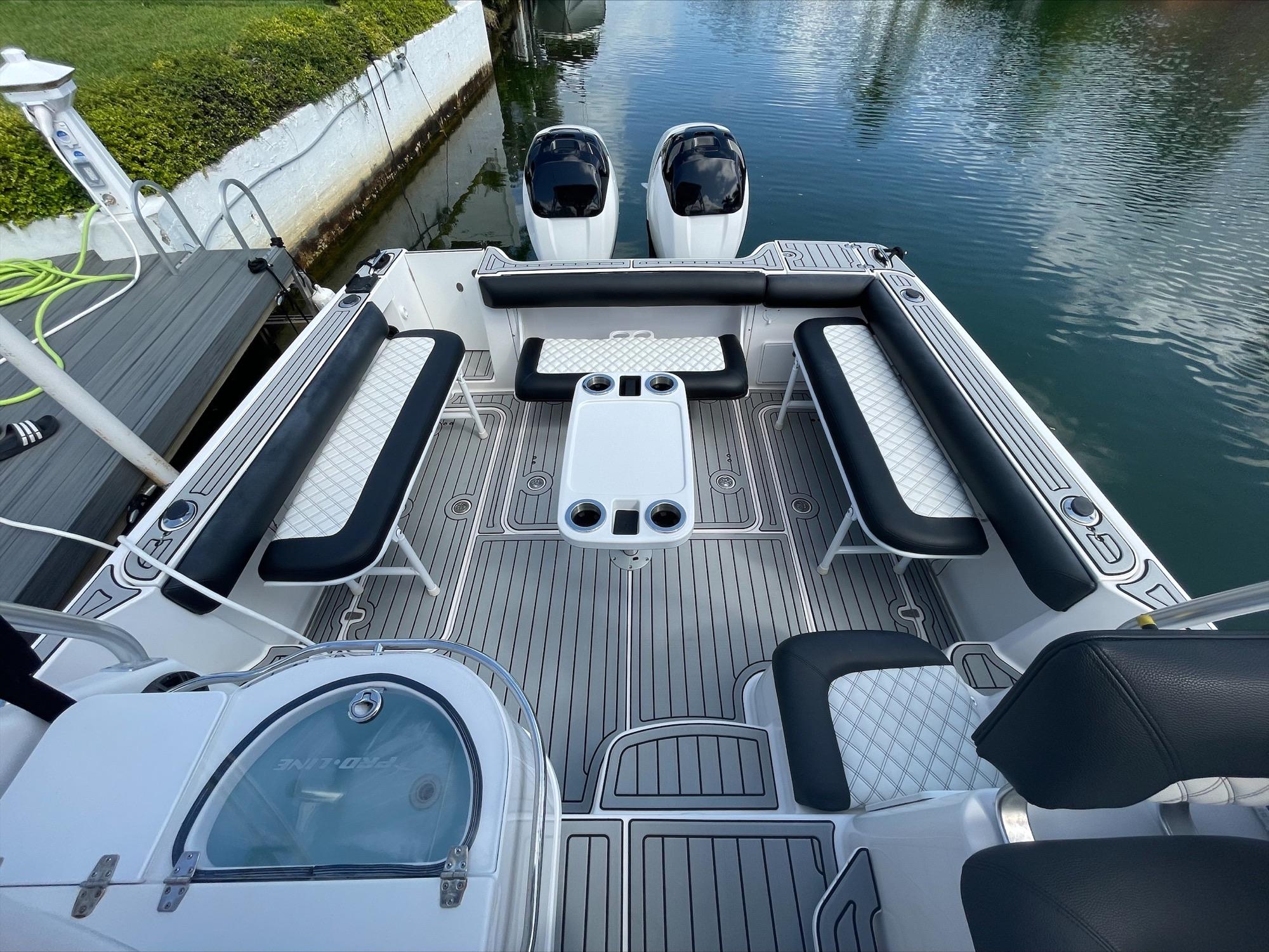 The boat features a spacious seating area with a central table.